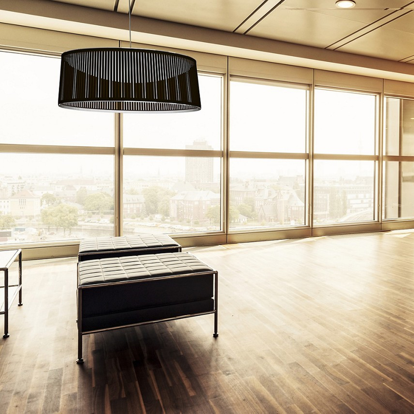Haworth Solis Drum Lighting in black color in office space above ottomans