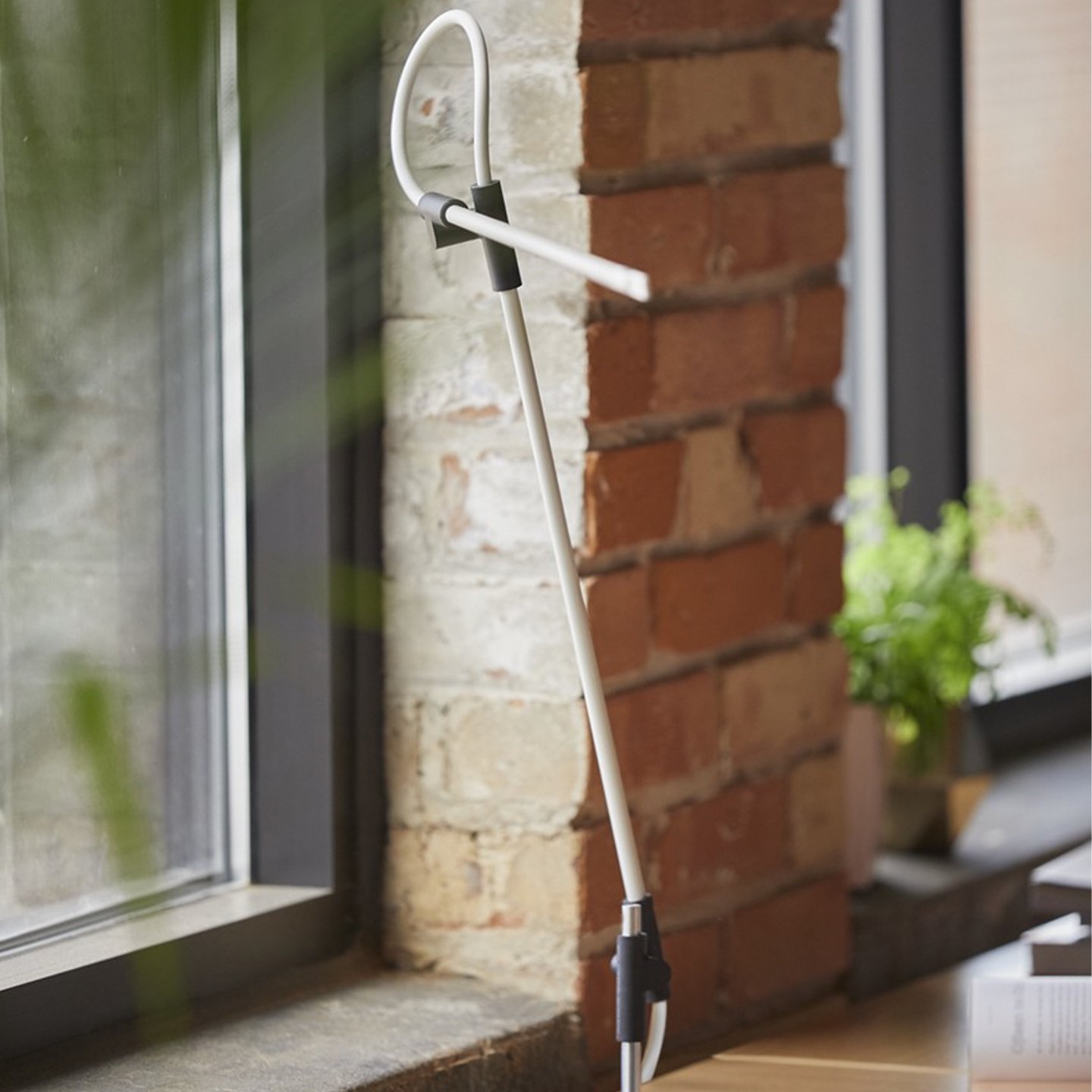 Haworth Superlight lighting in white color on wood desk with brick wall 