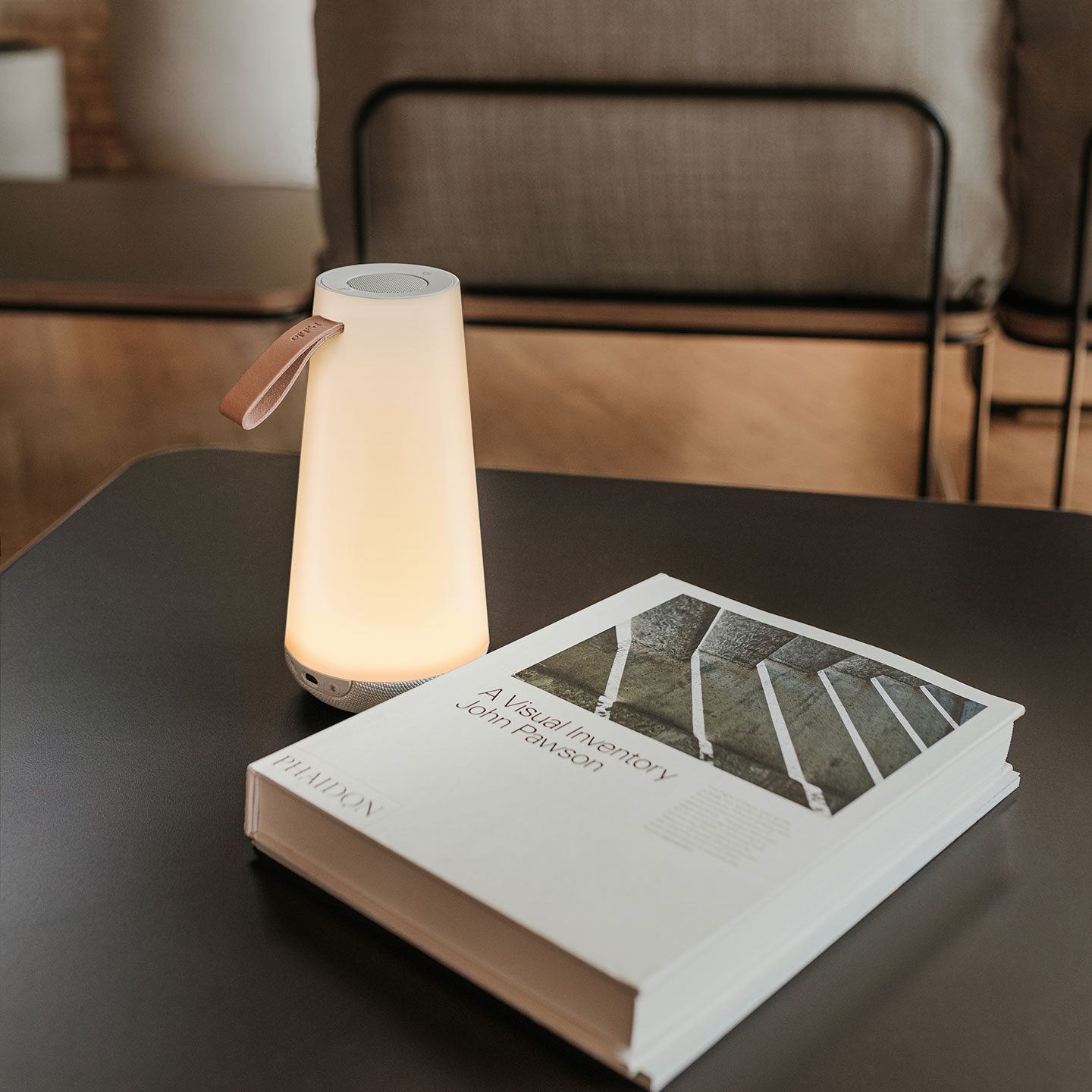 Haworth Uma Mini Lighting on black desk next to book