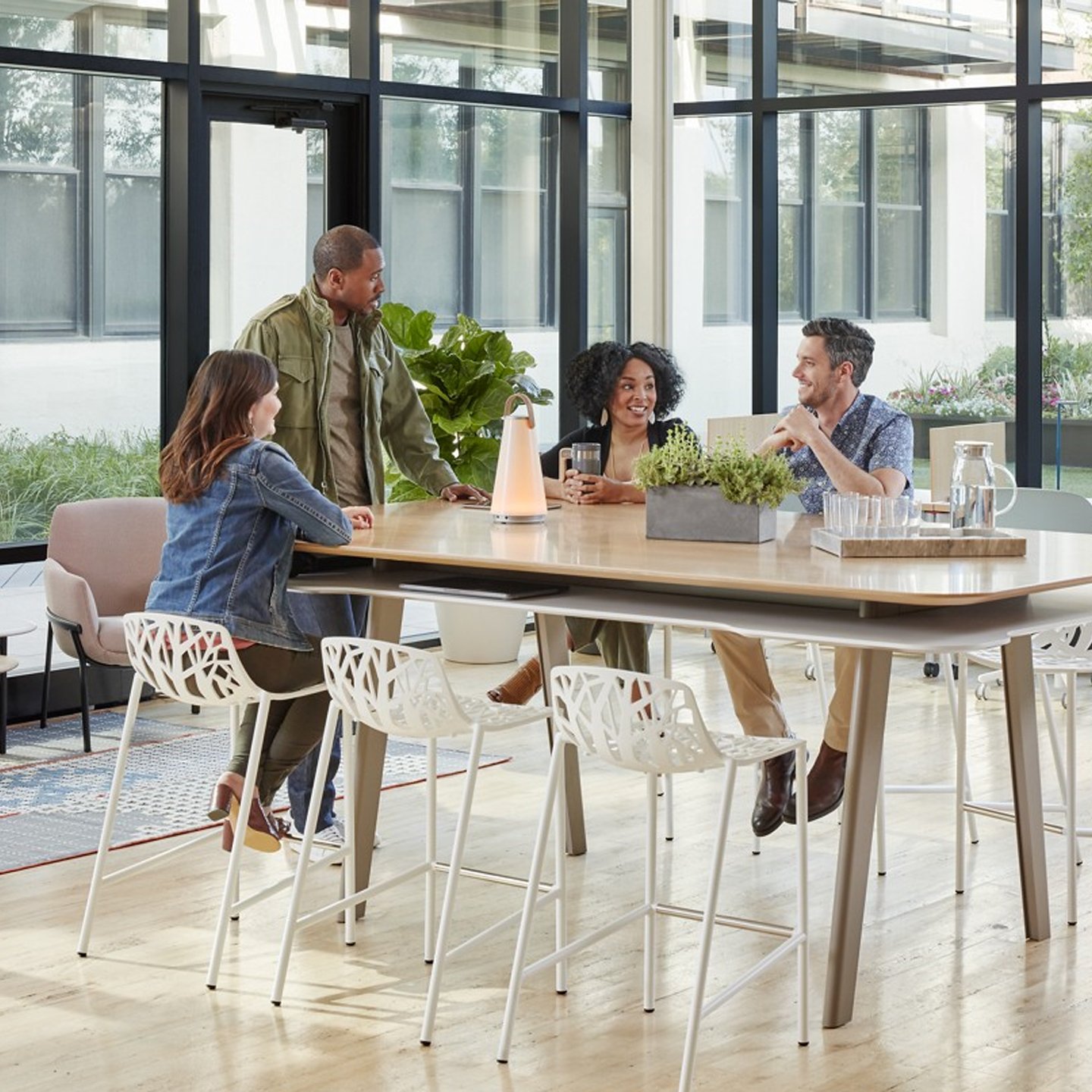 Haworth Uma Lighting in open office space at table for collaboration with employees working