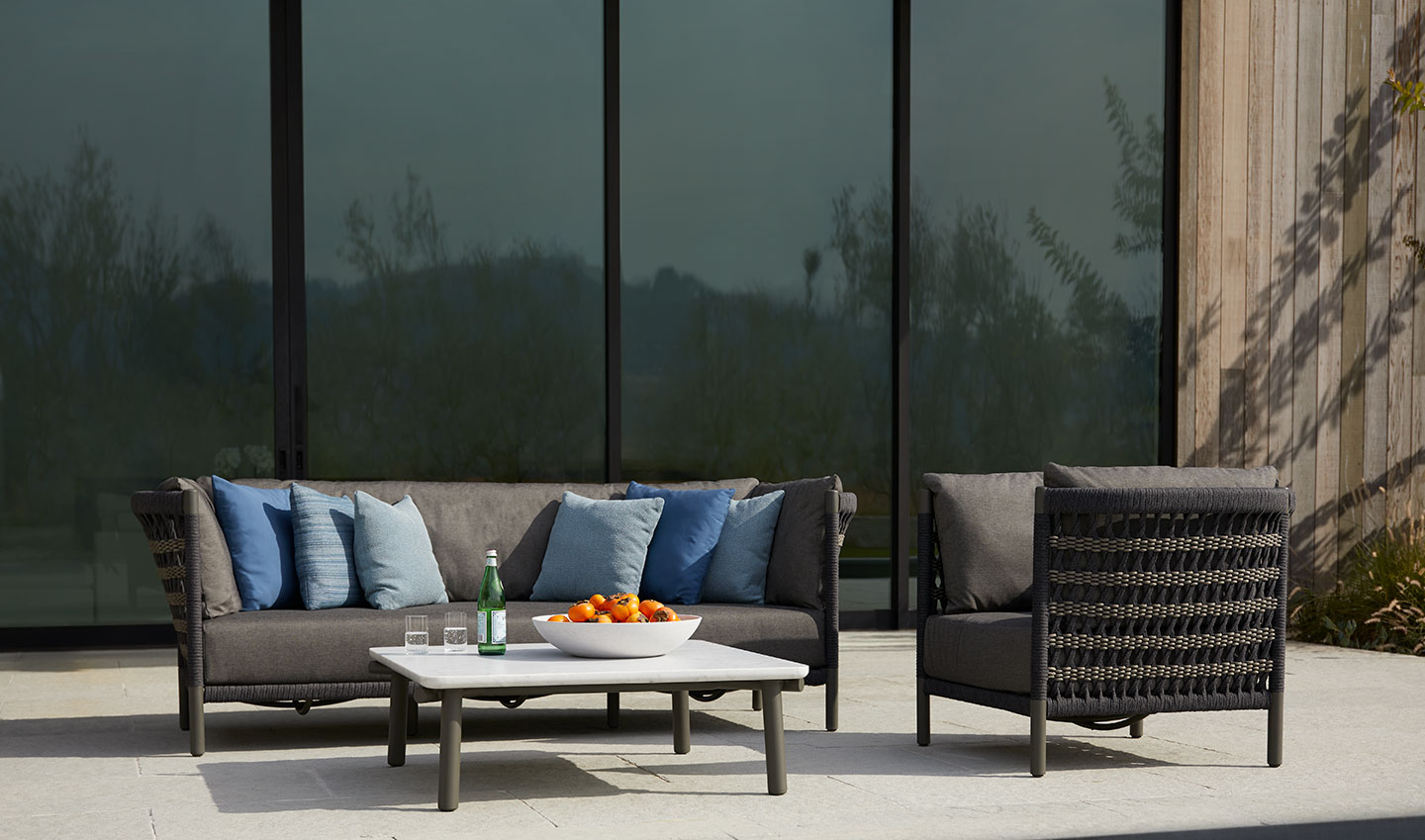 Haworth Anatra lounge sofa and chair in woven back and black upholstery in an open space