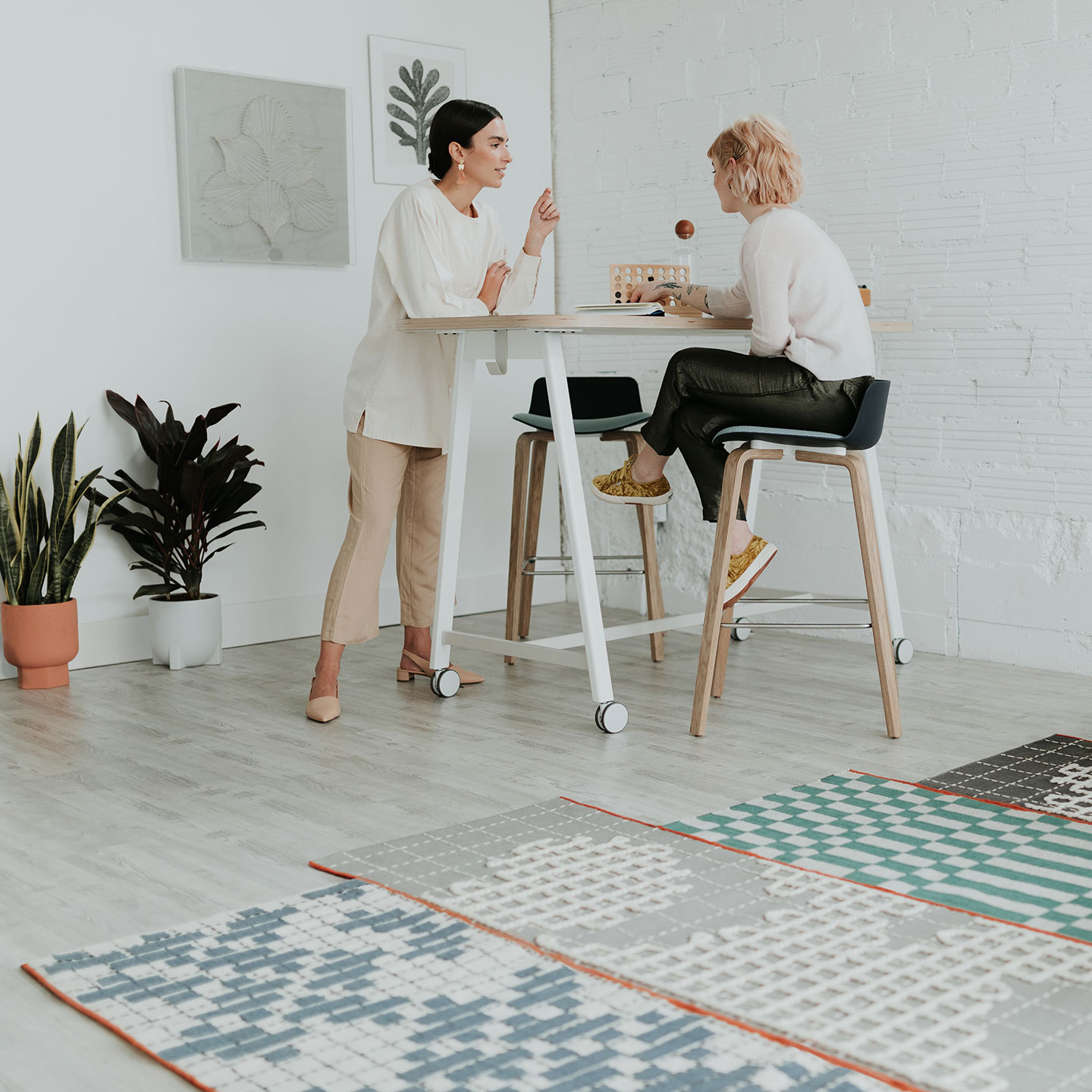 Haworth Bandas Space Rug in multiple colors by employees working at a tall desk 