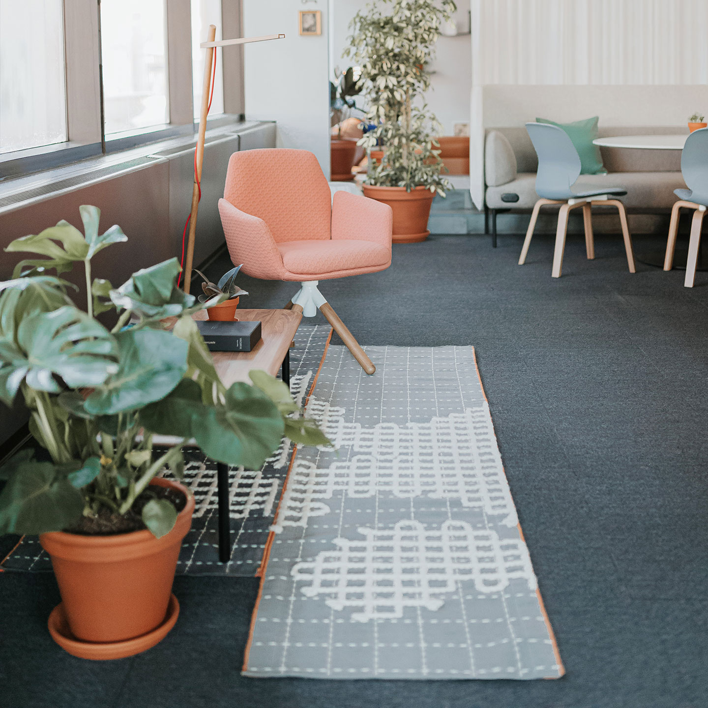 Haworth Bandas Space Rug in grey color under pink chair in office open lounge space