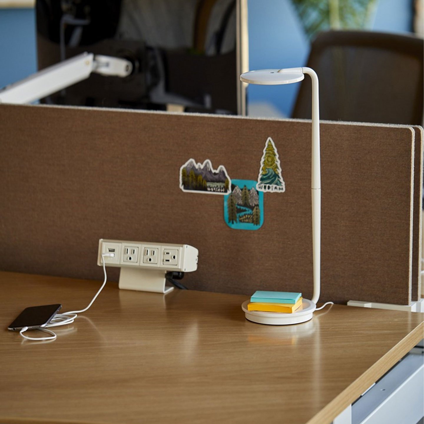 Haworth Belong Screen in etch brown on wood desk with power strip on desk and lamp
