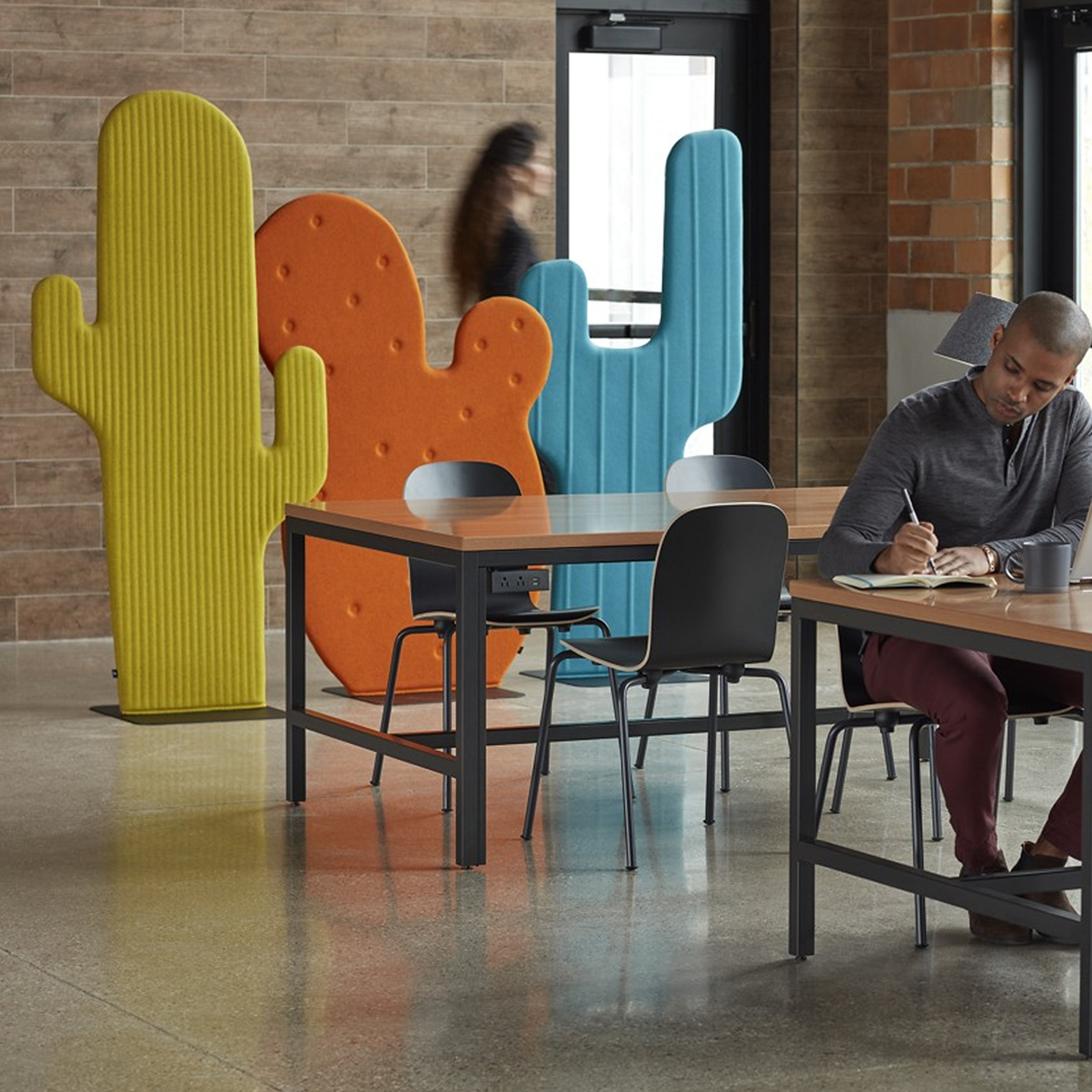 Haworth Buzzicactus screen in yellow, orange, and blue color in office space with employees working at collaboration table 