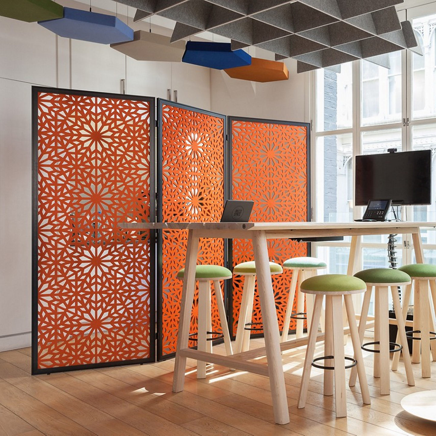 Haworth Buzzifalls Standing screen in orange color with black trim by open collaboration area