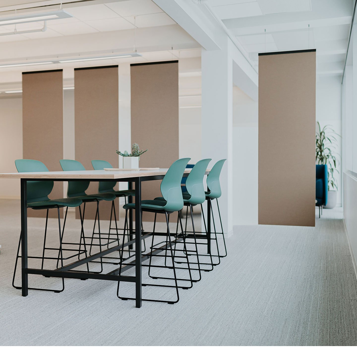 Haworth Buzzifalls screen in brown color in open office space and tall table for collaboration