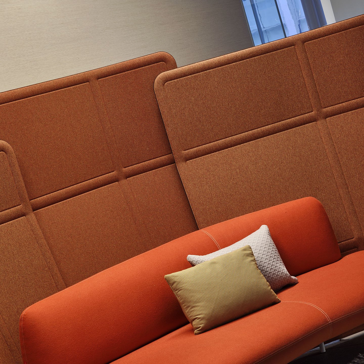 Haworth Openest Plume Screen in orange color over orange couch in open space