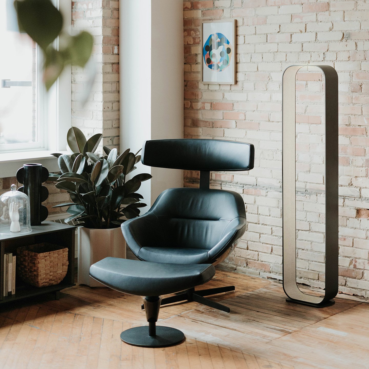 Haworth Auckland green chair with ottoman and contour lighting in a social space