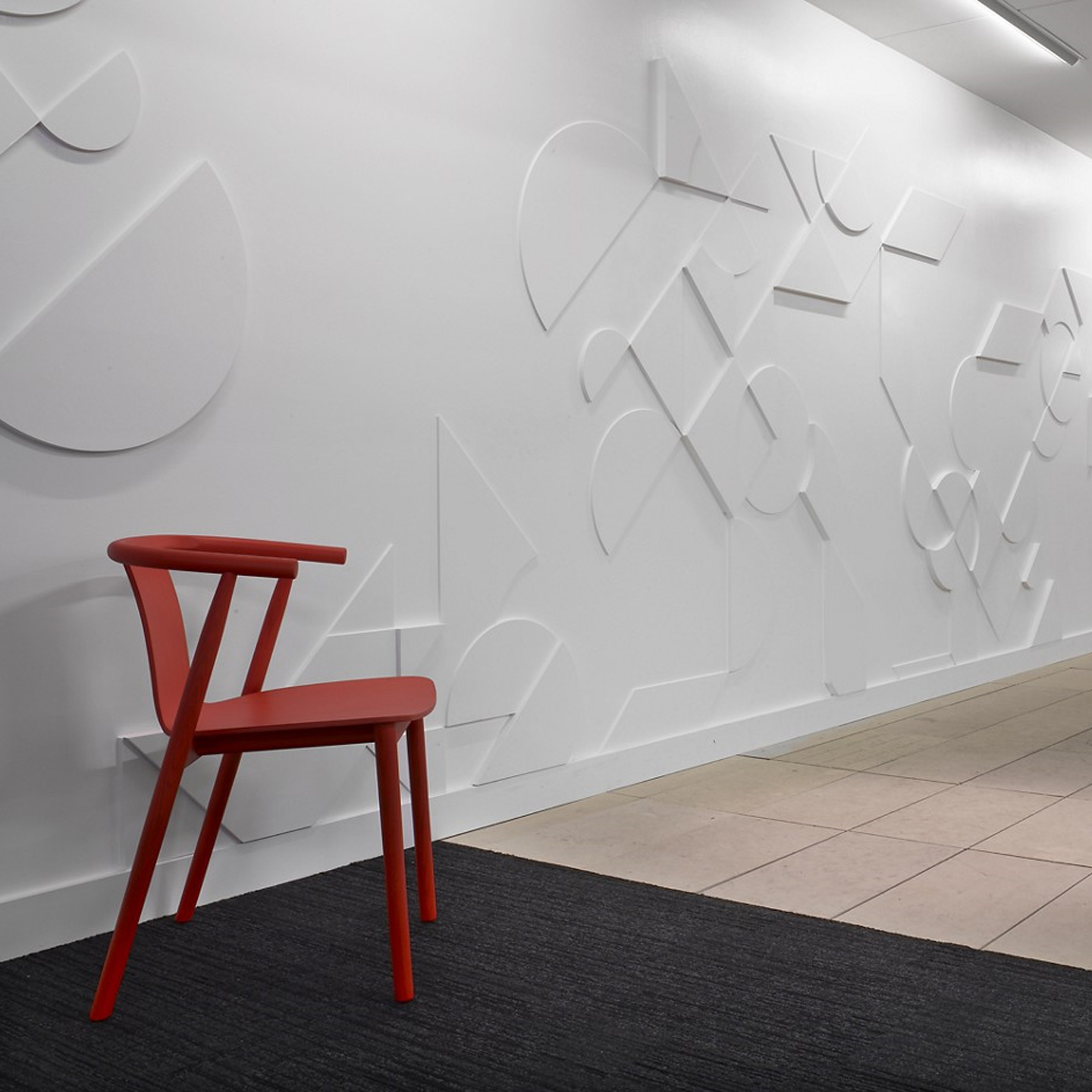 Haworth Bac chair in red color in an open floor