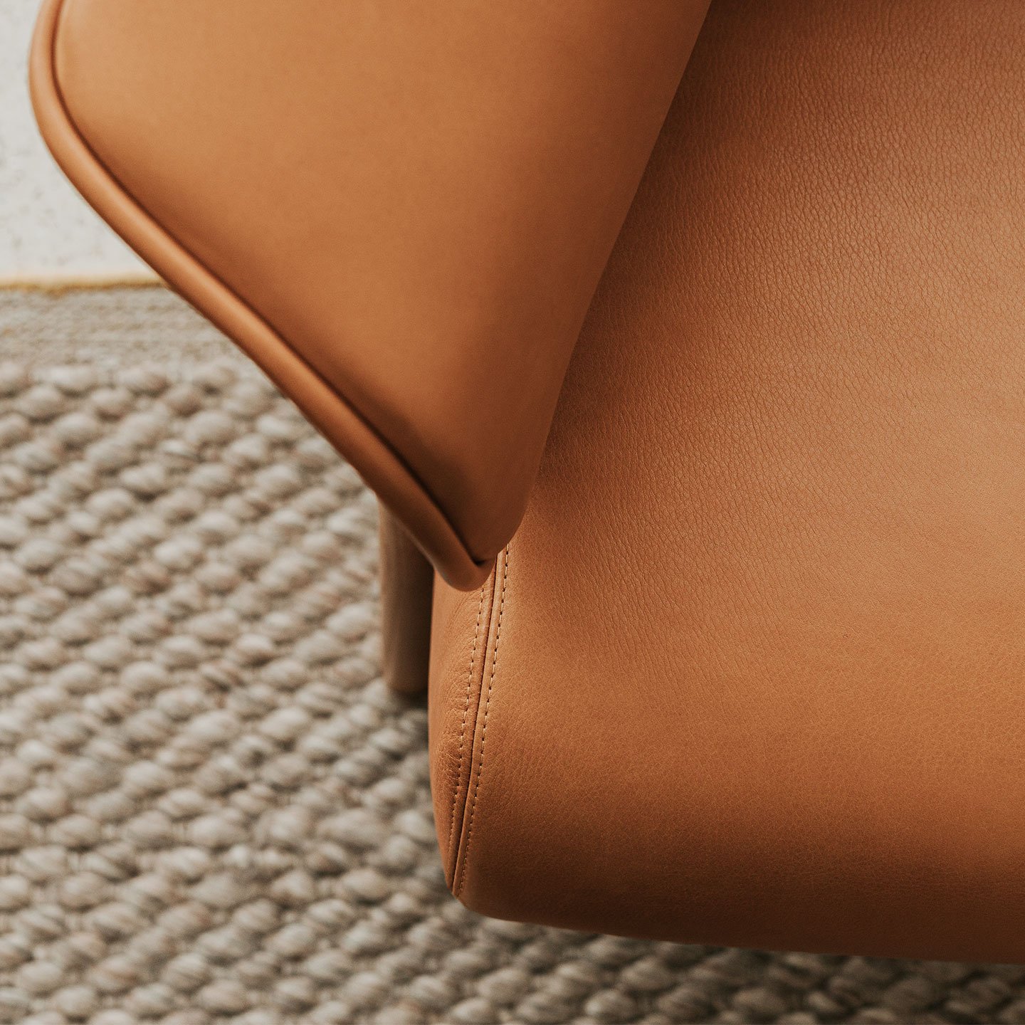 Haworth Back Wing chair in tan leather focusing on the armrest
