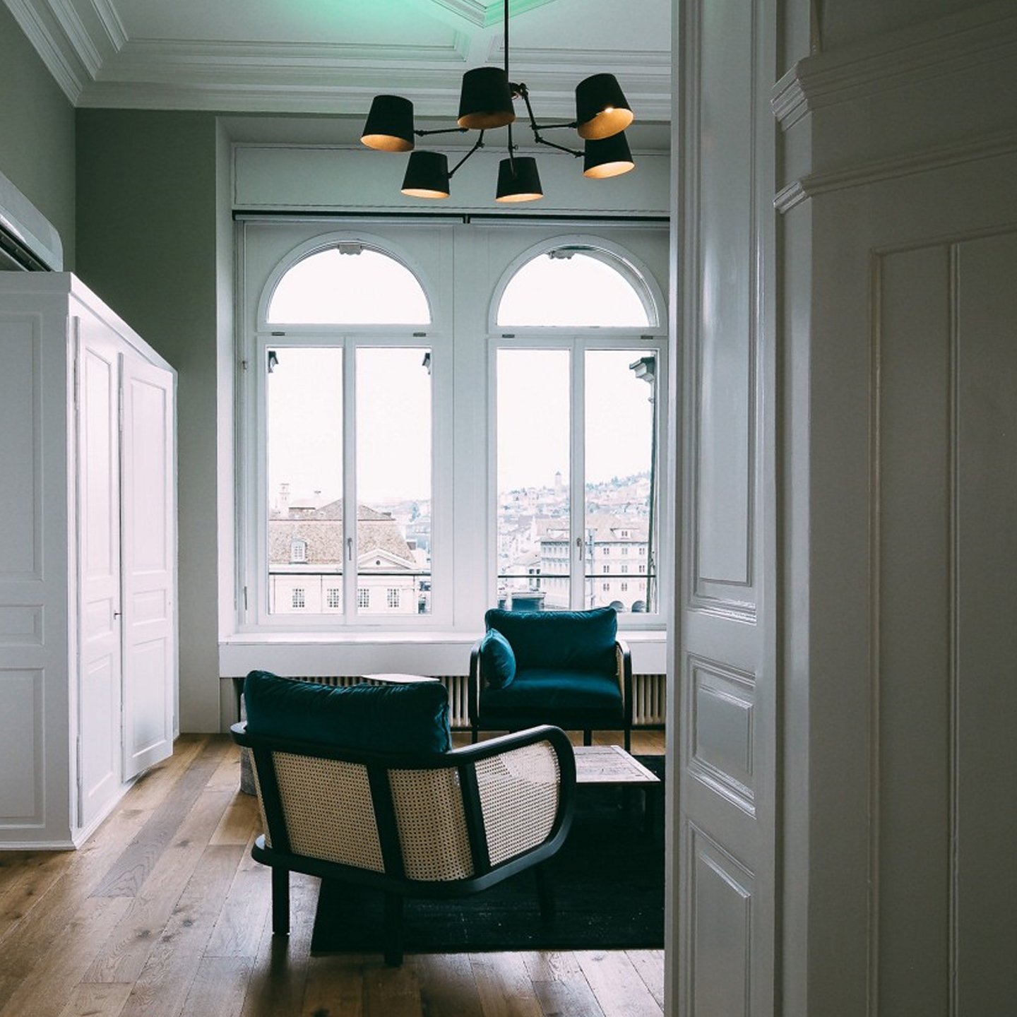 Haworth Buzzicane chairs in teal color in a living room by the window