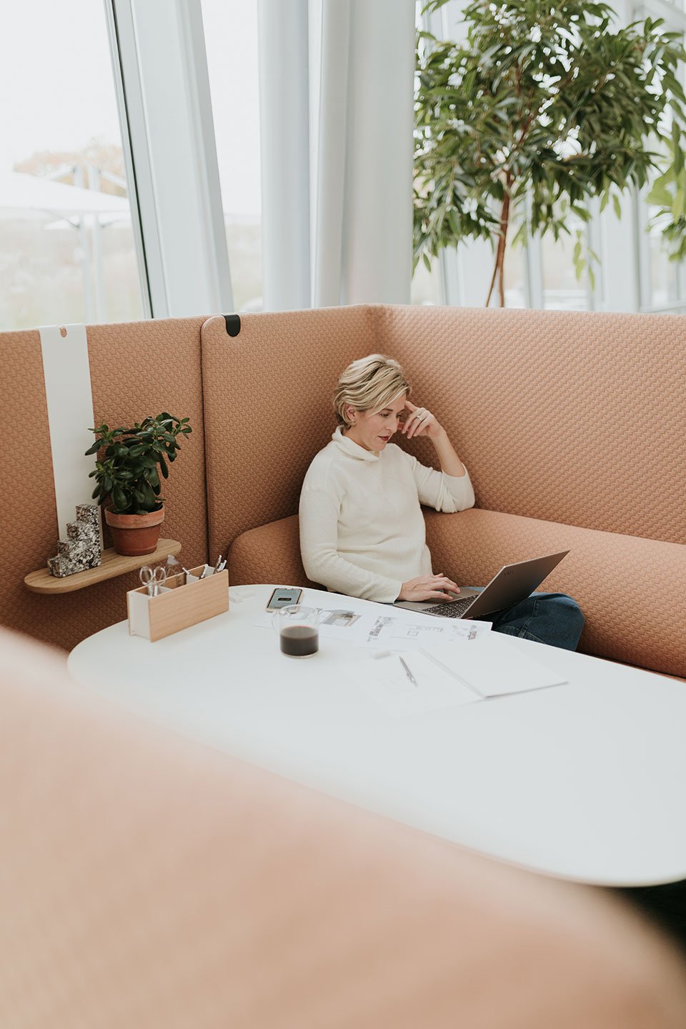 Haworth Cabana lounge connector screen in peach color offering a private space for discussion in an open office floor plan