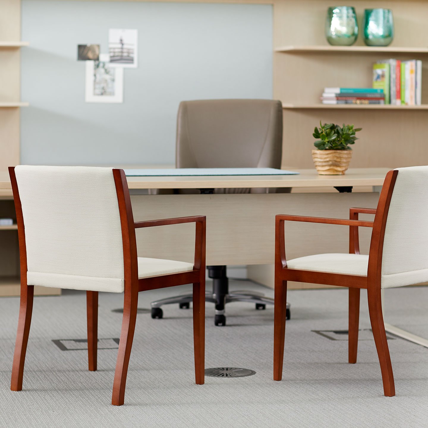 Haworth Candor chairs in off-white and dark brown in a office room at a large office desk
