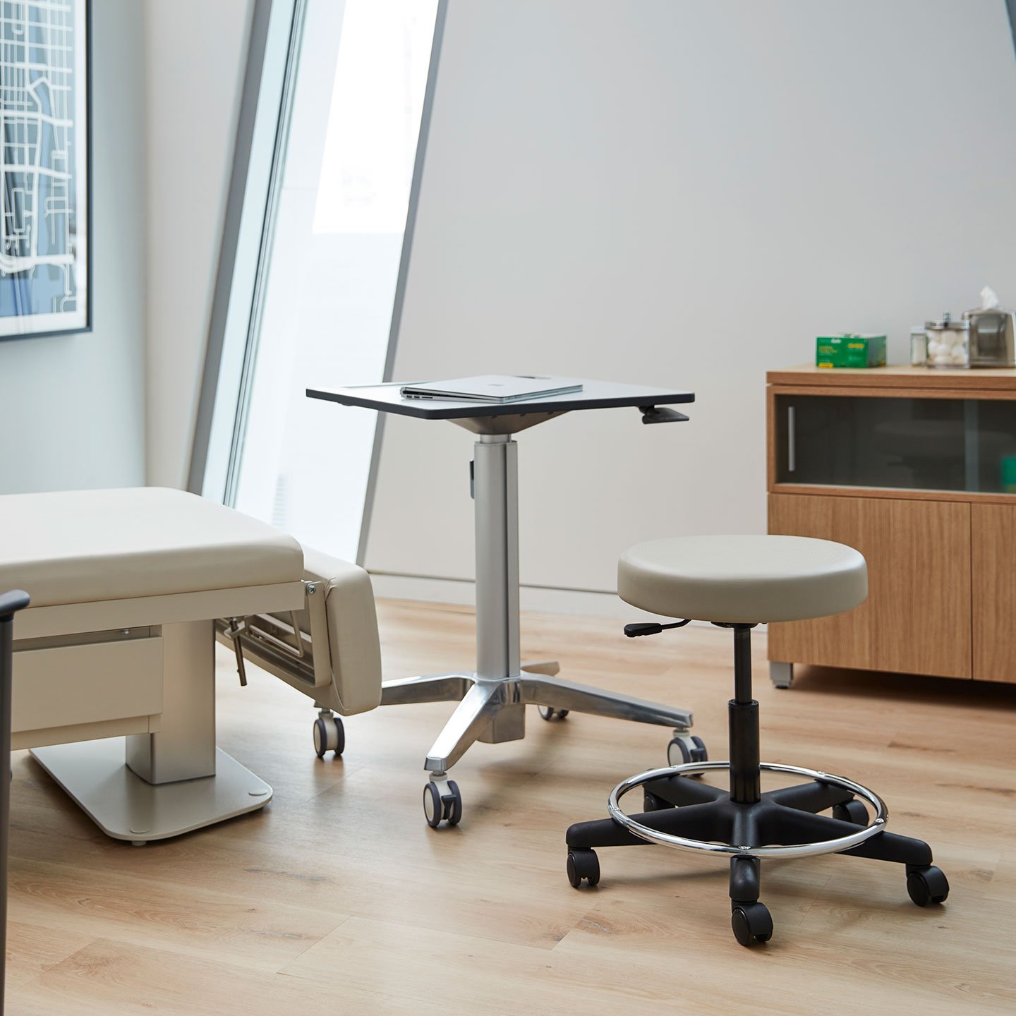 Haworth Exam stool in beige seating and swivel base in a doctor's consultation room