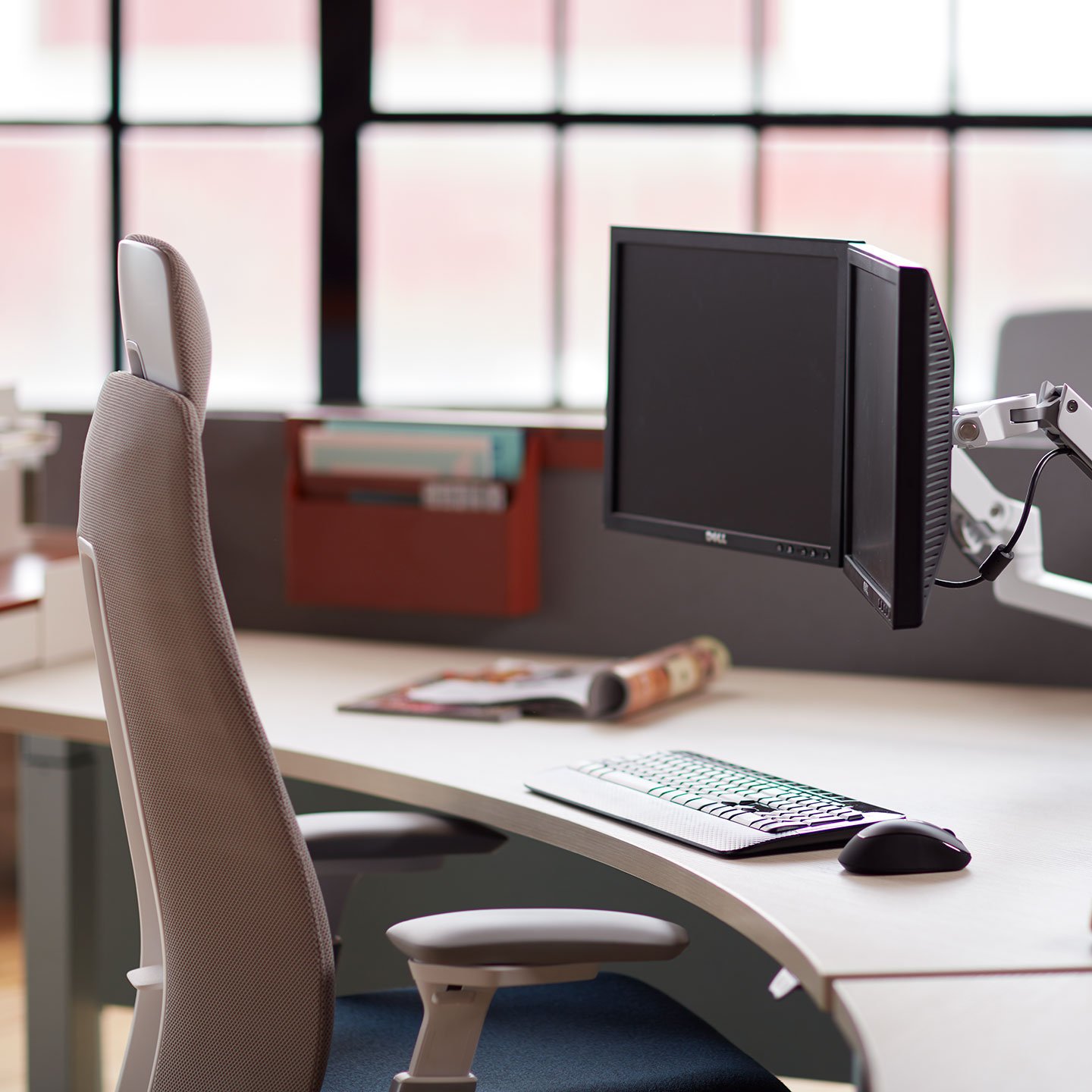 Haworth Fern Executive Task chair in fuschia color at a desk in a office room