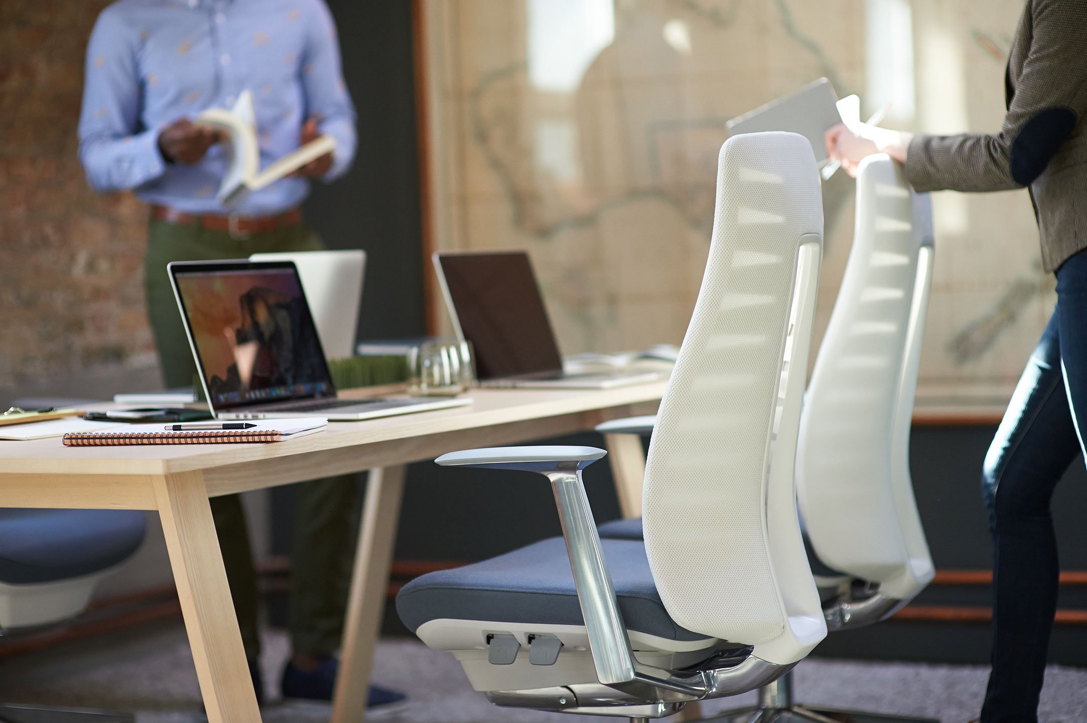 Haworth Fern task chairs in white upholstery at a conference table in an open office space