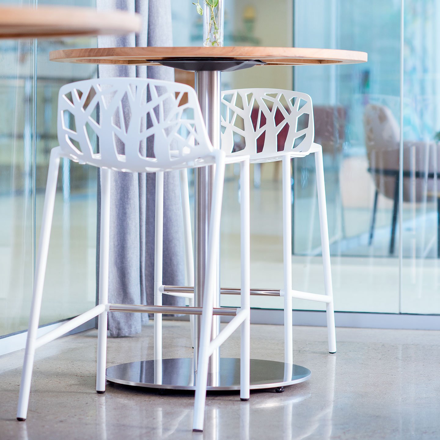 Haworth Forest stools in white in an outdoor space at a circular table