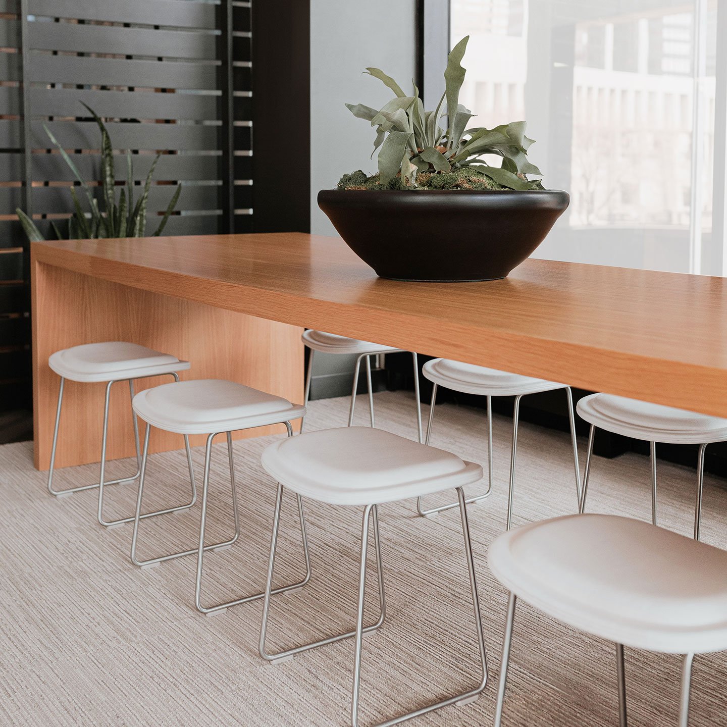 Haworth Hi-Pad stools in white upholstery at a casual seating area