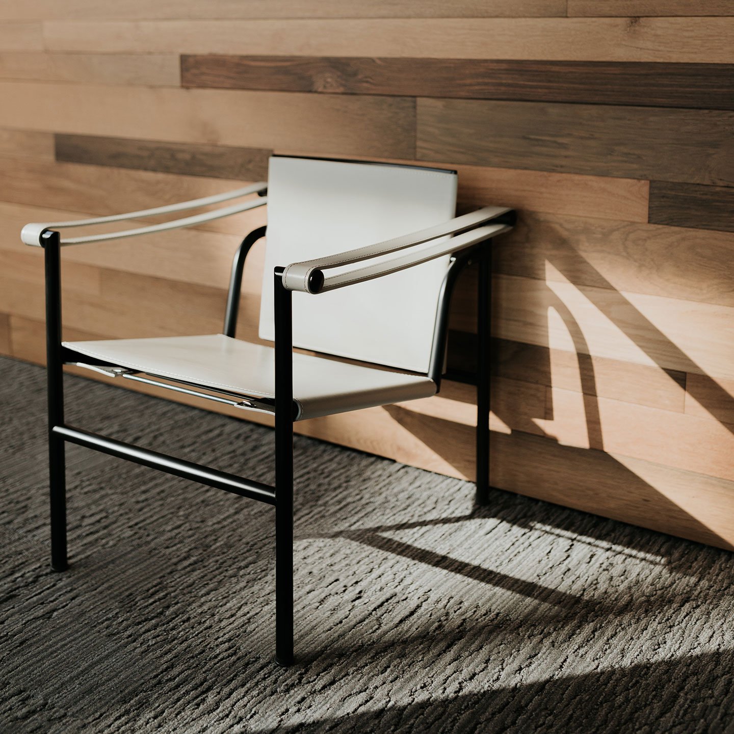 Haworth LC1 chair in beige color against a brown wood backdrop