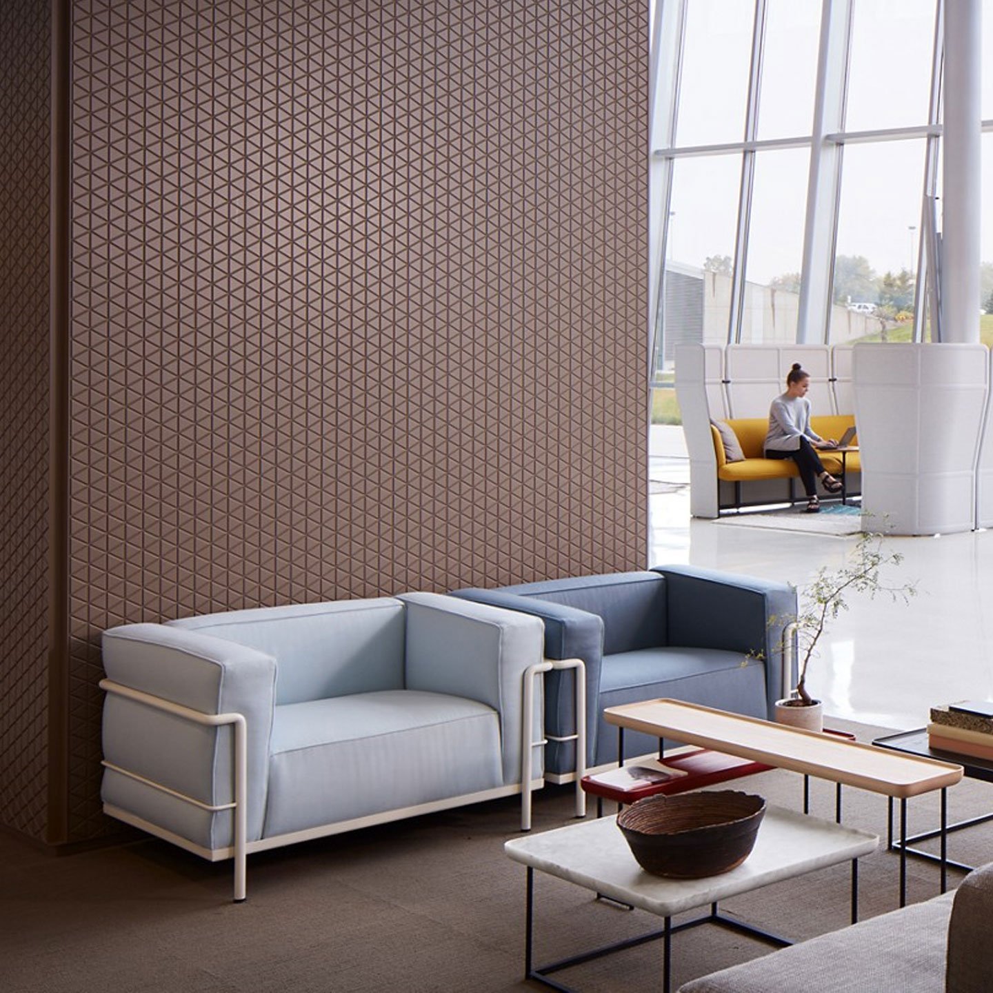 Haworth LC3 lounge chair in light blue and dark grey upholstery in a office lobby