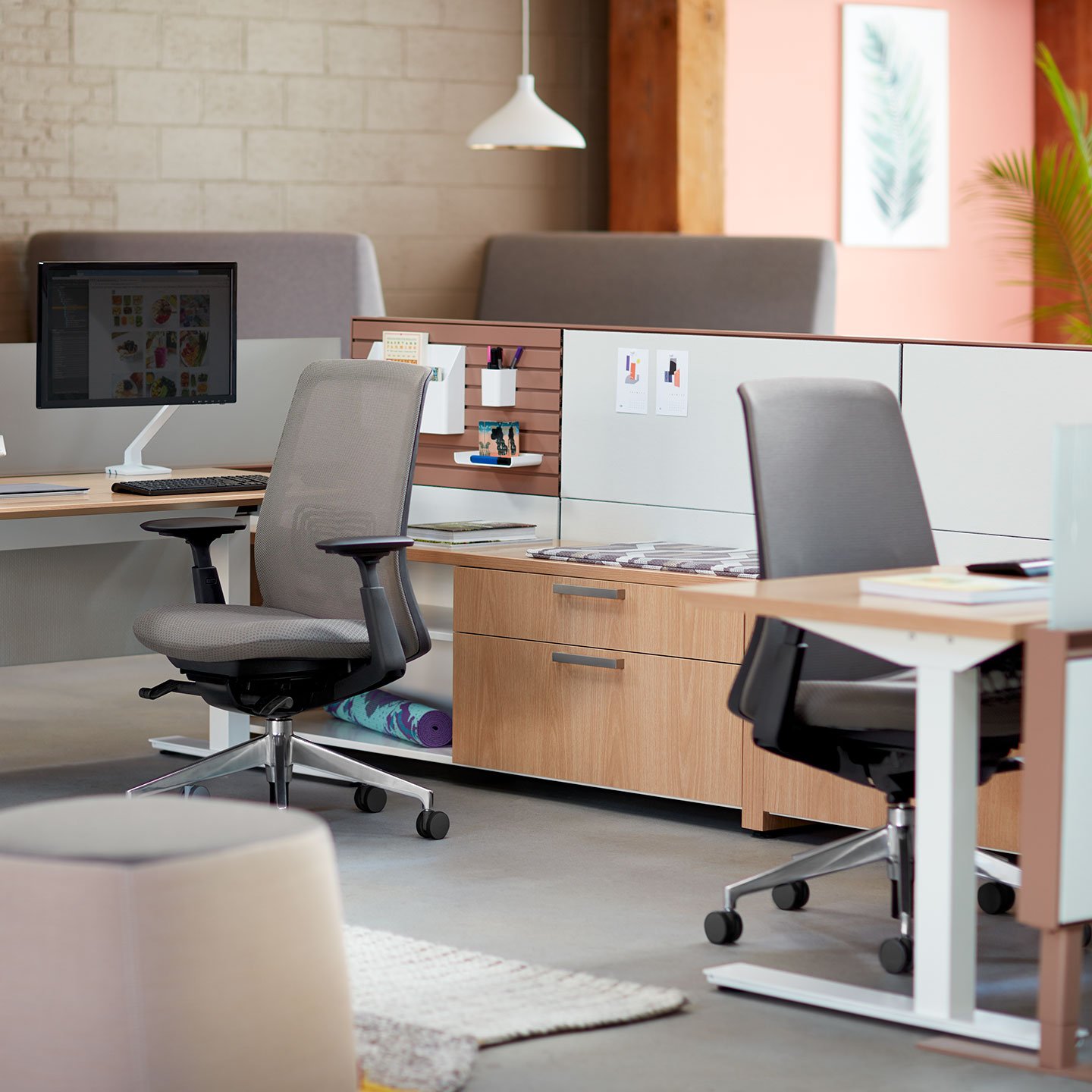 A Series storage at individual workspace with gray and black Soji chair.