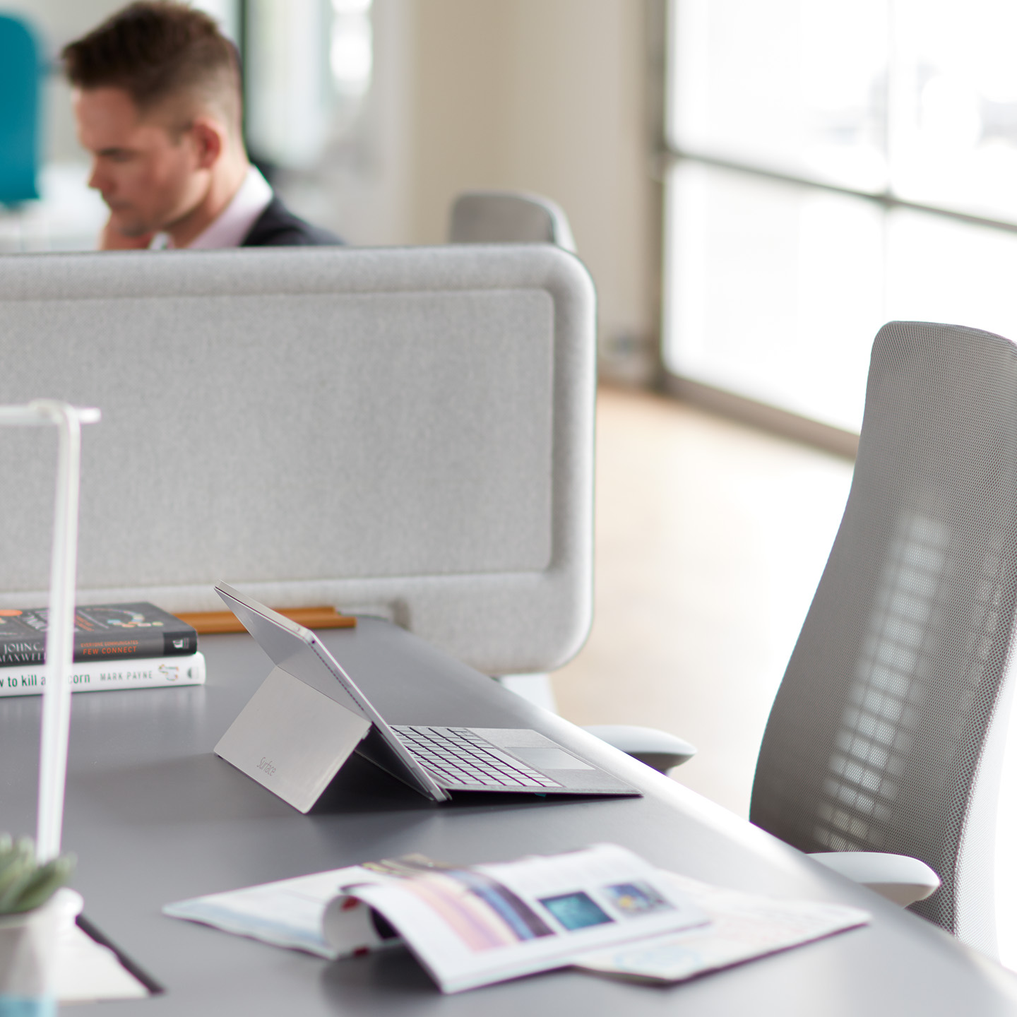 Active Components personal screen divider in gray at individual workspace with Fern chair in gray