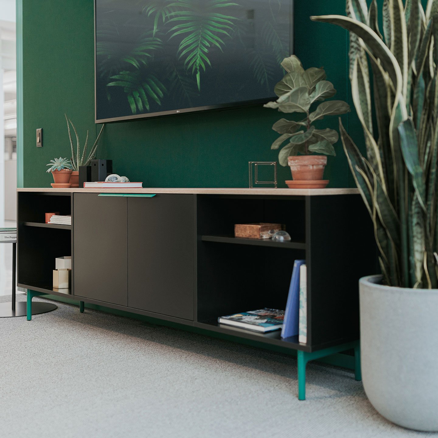 Be_Hold storage credenza in black and green legs with open shelves and hinge doors.