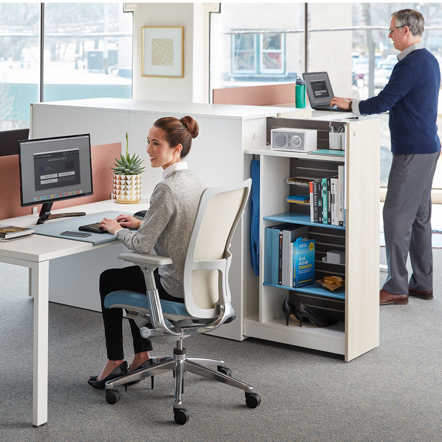 Haworth Beside storage pantry in white in a office space next to a workstation