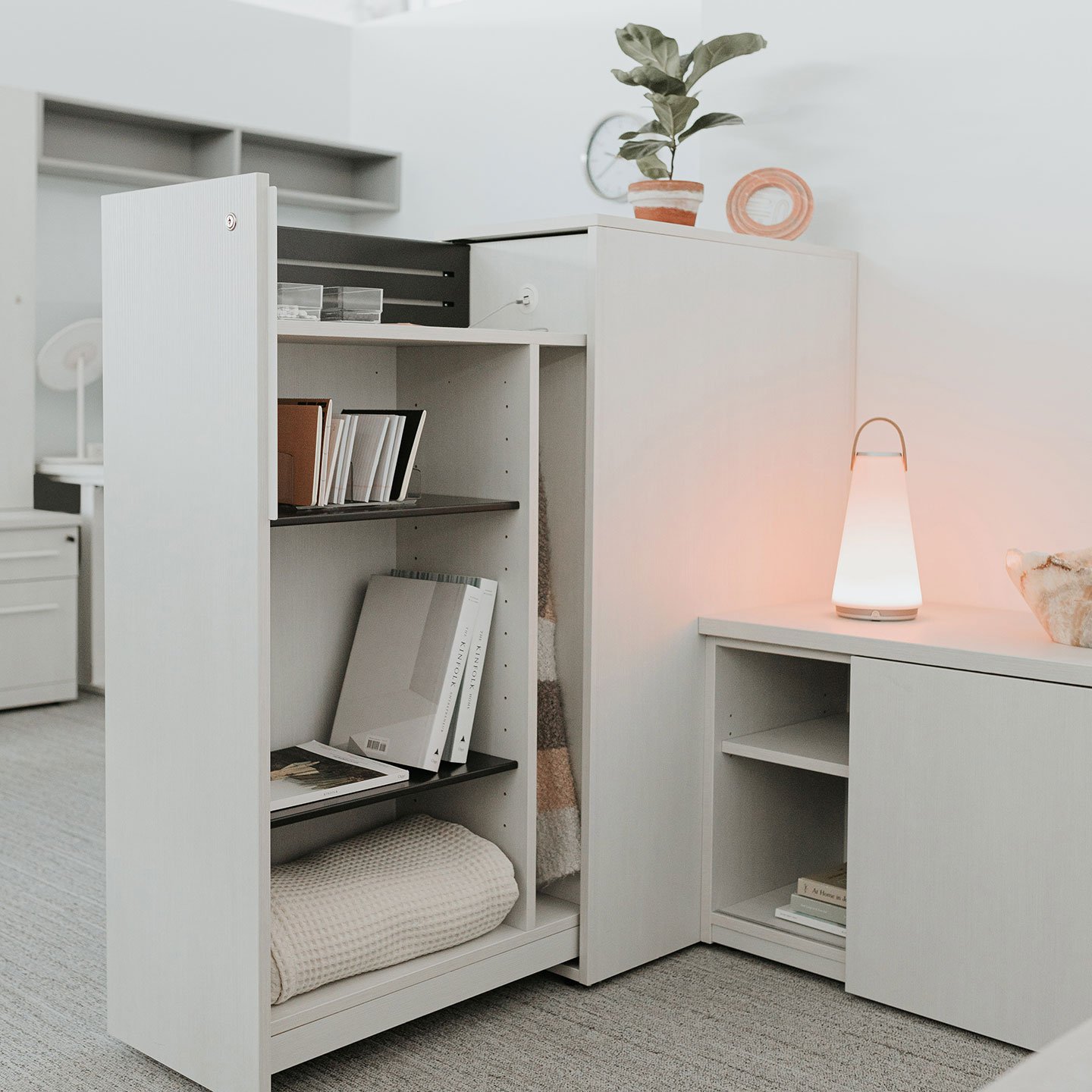 Haworth Beside storage pantry in white with a UMA lamp next to it inside a room