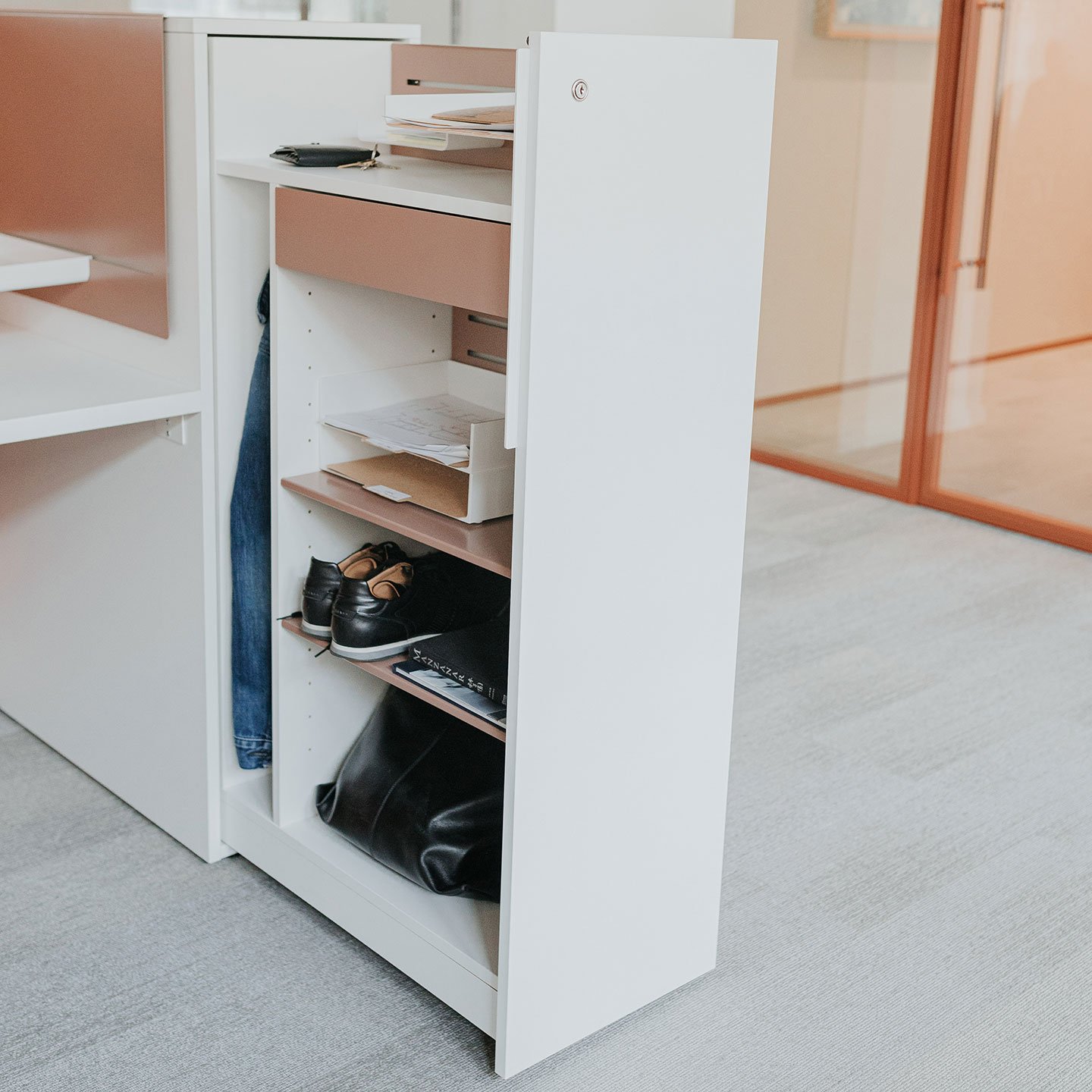 Beside storage pantry in white with shelves and lock door