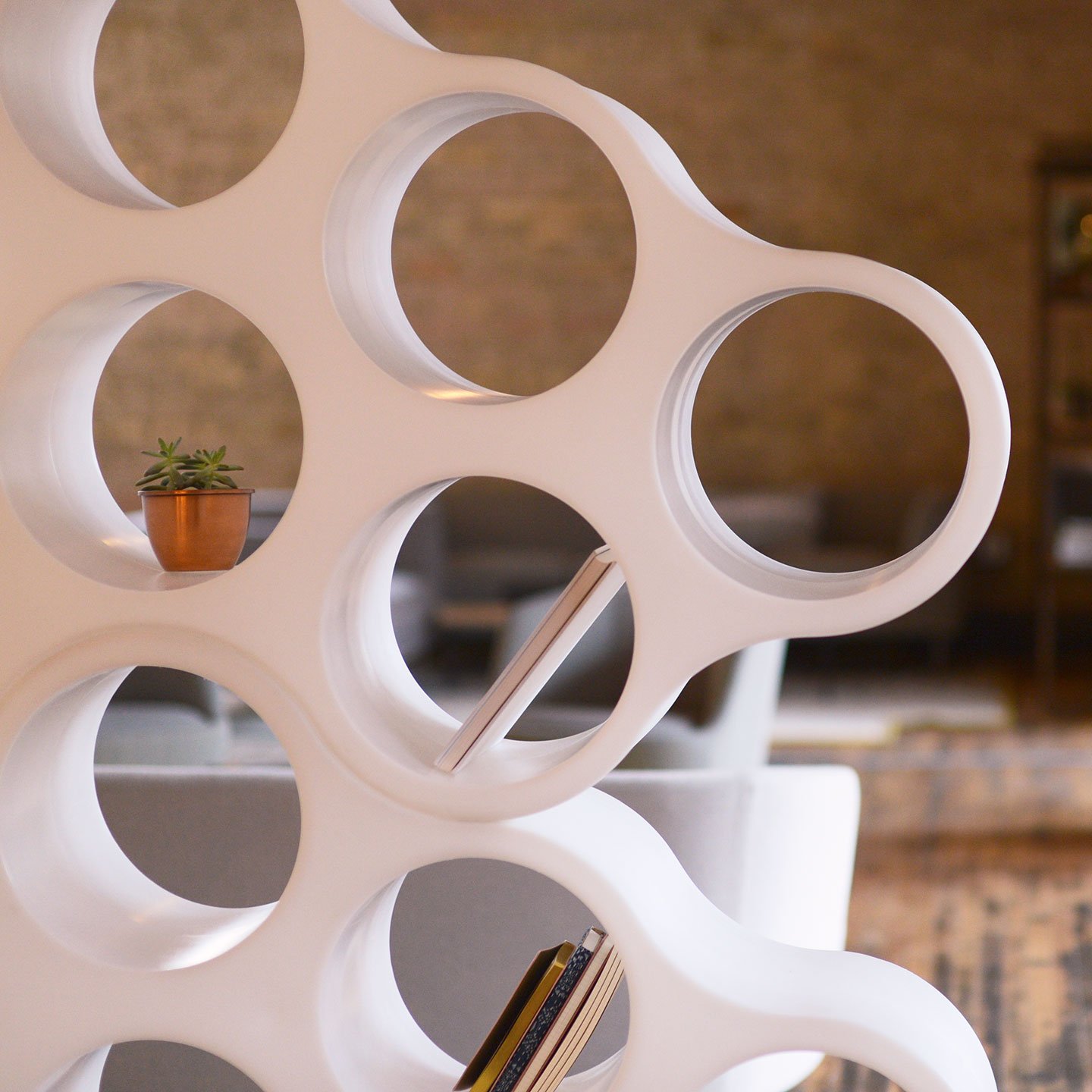 Close up of white cloud bookshelf with books and décor on shelves. 