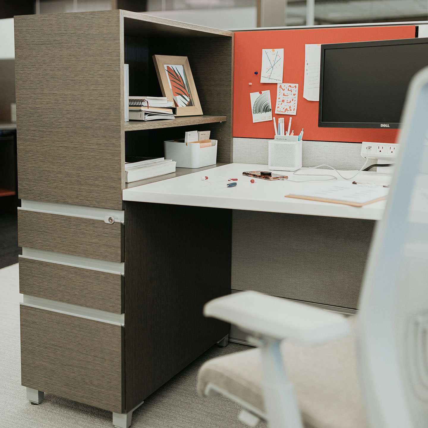 Compose storage unite at individual workspace with lock drawers and open shelves.   