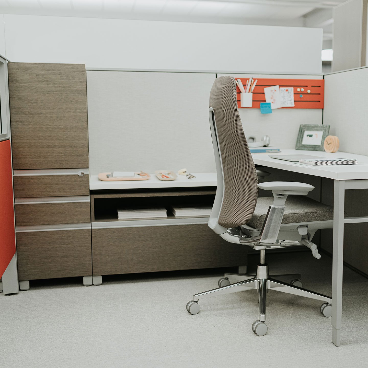 Compose storage unit with lock and file drawers at an individual workspace with gray fern chair.  