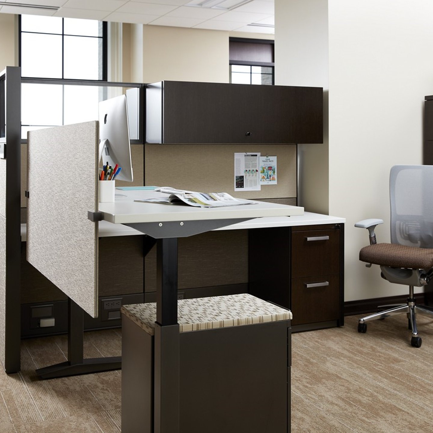 Compose storage unit in dark wood at workstation with classic door handles on drawers.