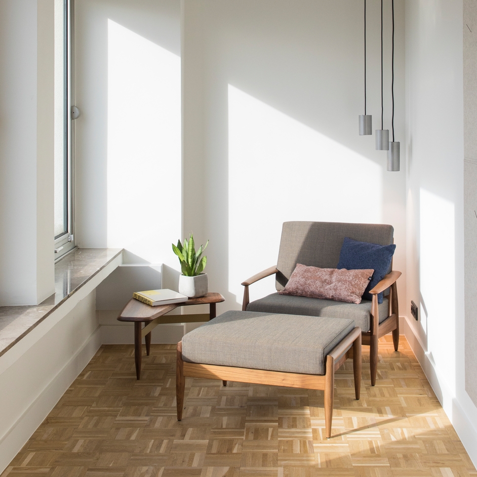 Haworth BuzziNordic Table in walnut in reading nook with chair and ottoman