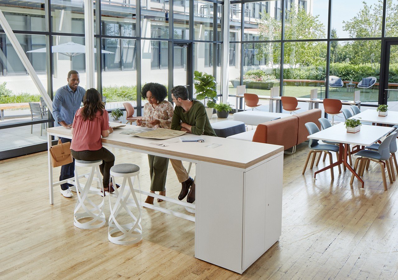 Haworth Cultivate table with 2 white legs and drawers in a open meeting area for collaboration