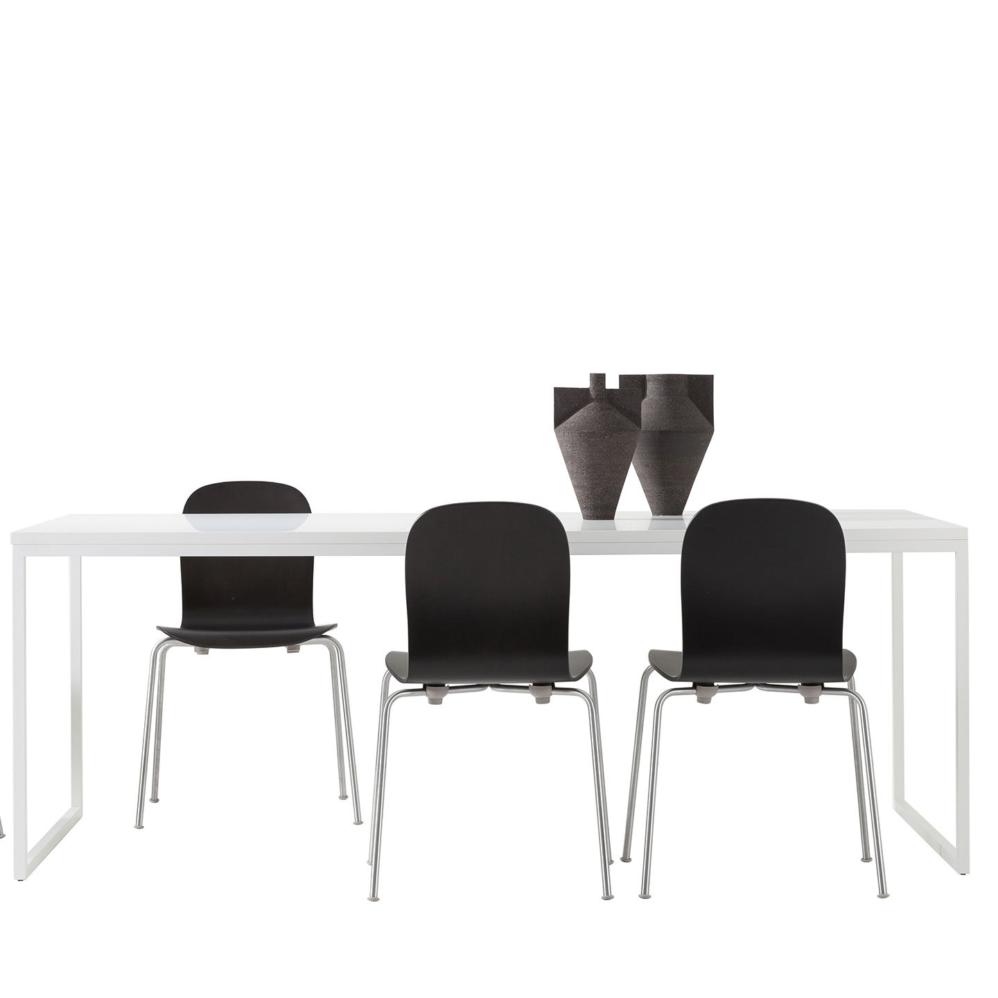 Haworth Fronzoni 64 table with 2 legs in matte white finish as a dining room table with a white backdrop