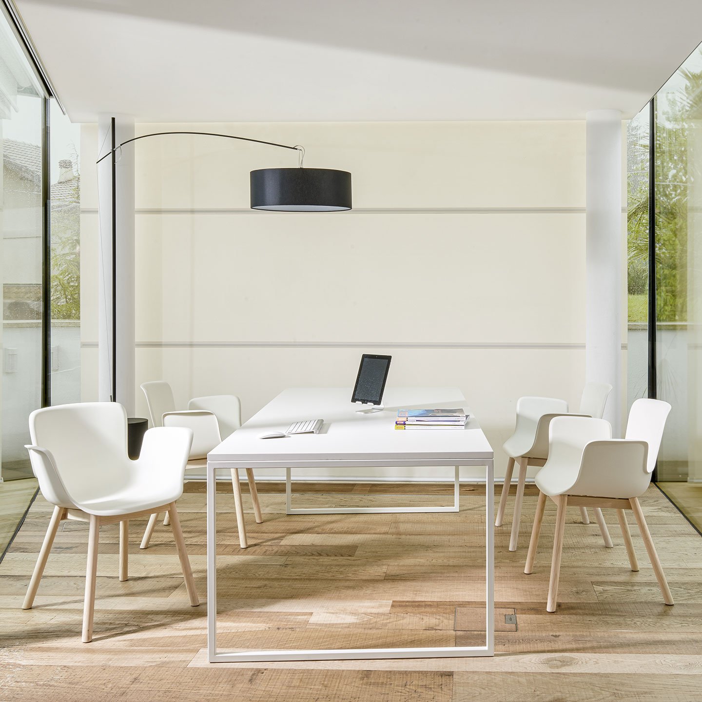 Haworth Fronzoni 64 table with 2 legs in matte white top finish in a closed meeting room surrounded by glass