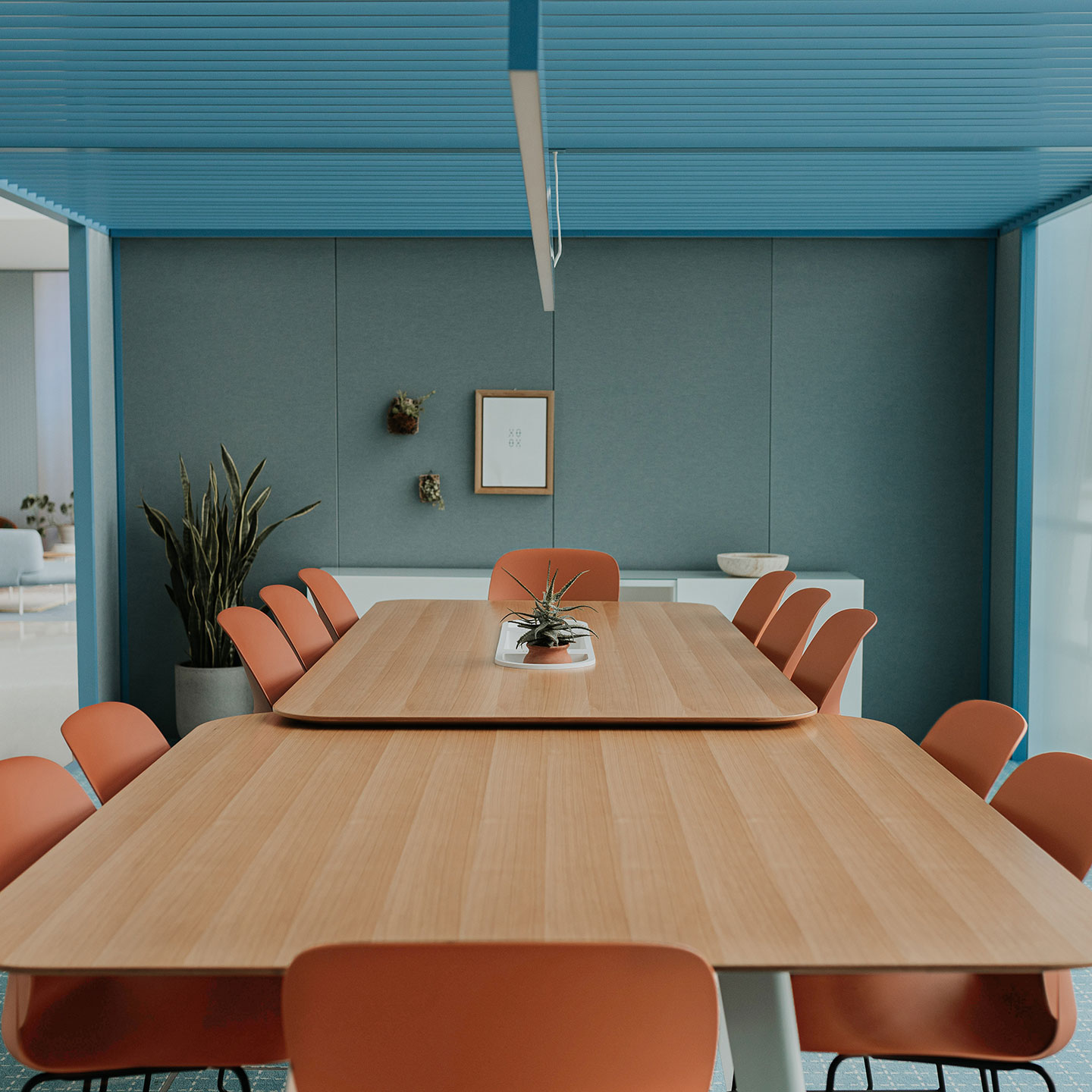 Haworth Immerse Office Conference Table with a wood top in a closed off meeting room