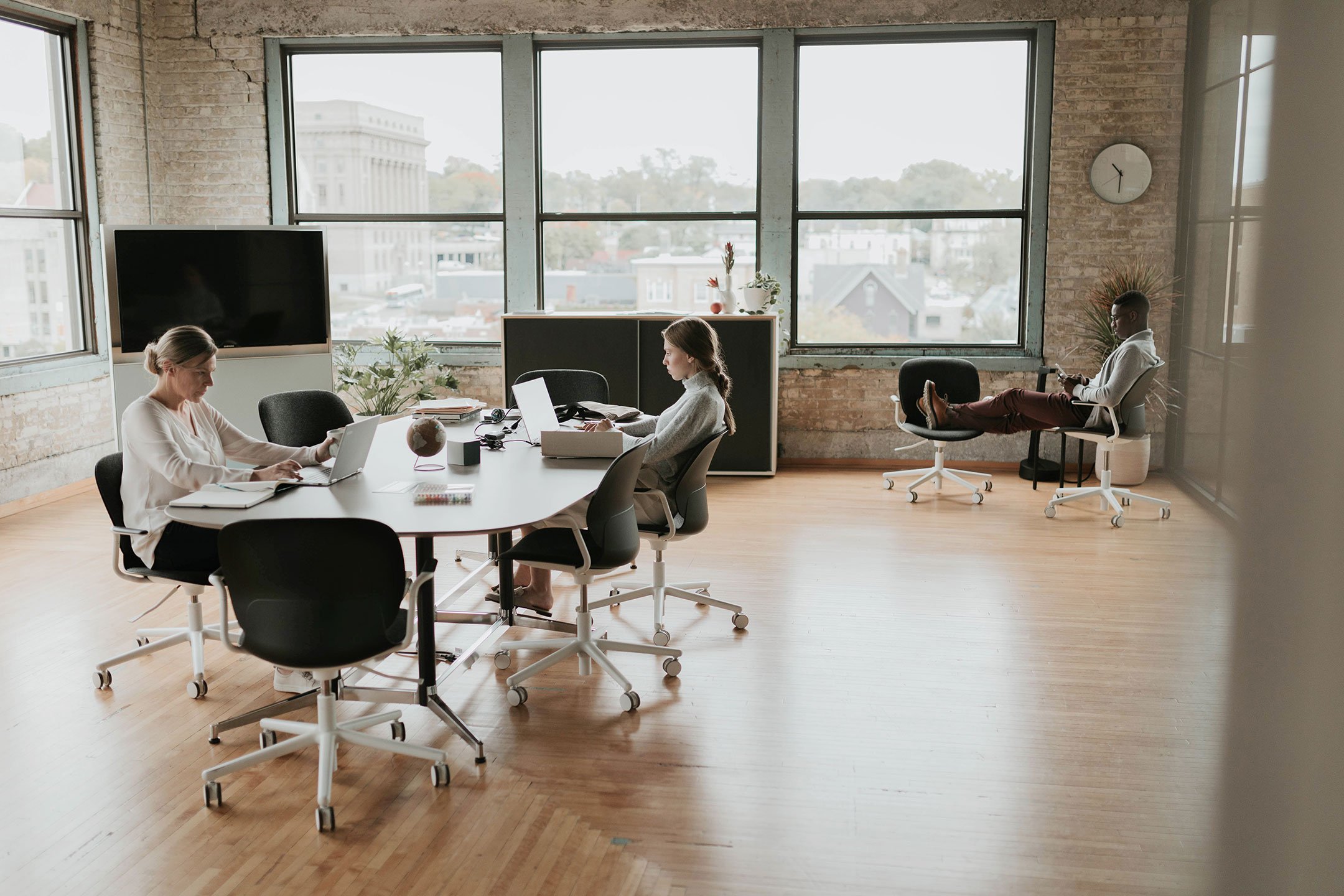 Haworth Jive Table in a office closed meeting room with tv and multiple Haworth chairs