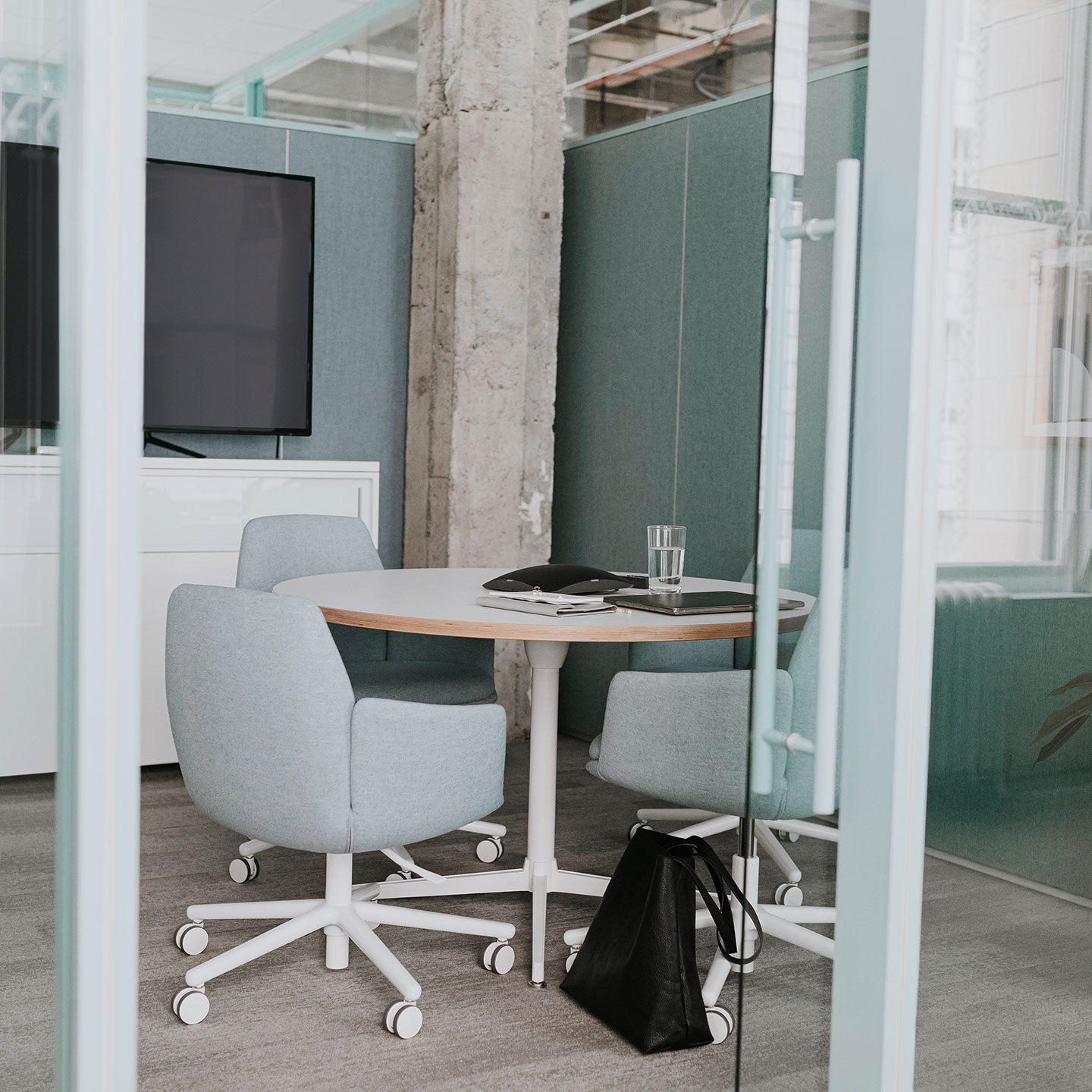 Haworth Jive Table with circular base and top in small closed collaborative work room