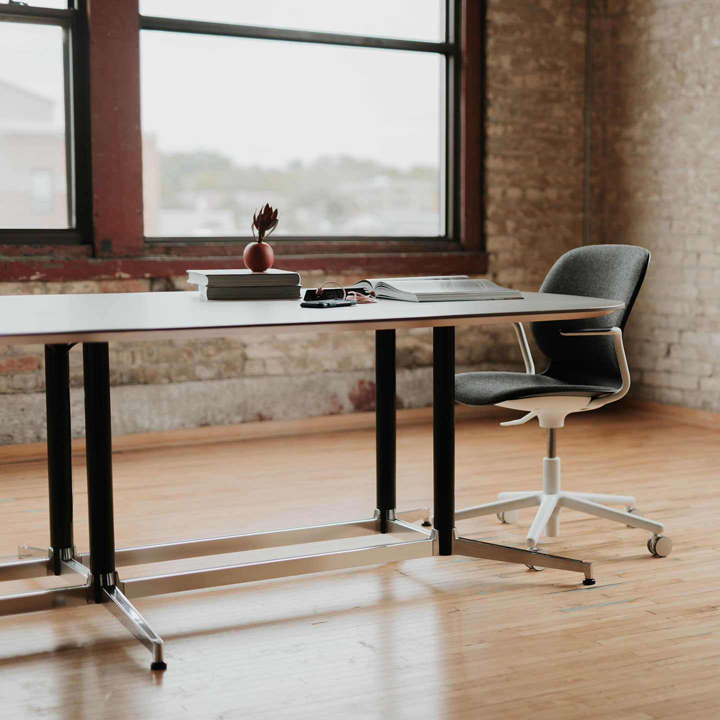 Haworth Jive Table in a closed office area with a reading set up on top of the table and a single chair