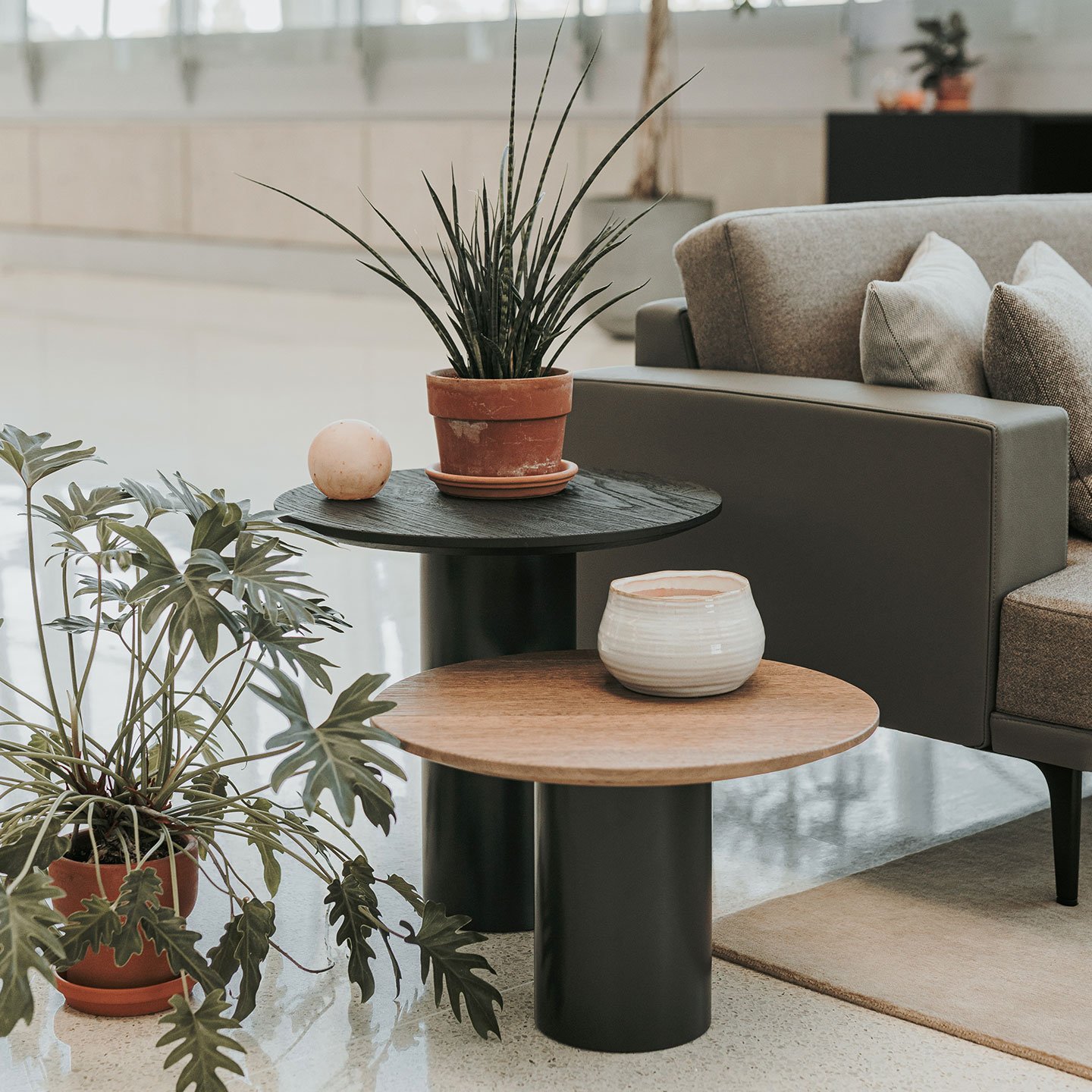 Haworth Mush Table in a office lobby as a side table with a plant on it