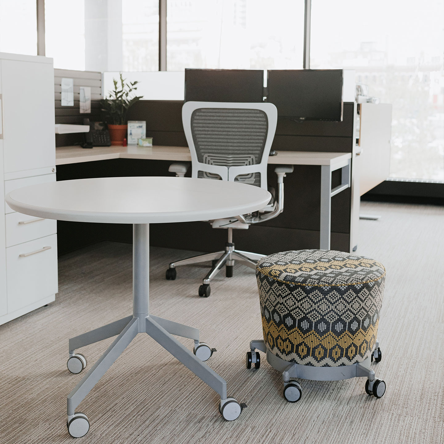 Haworth Planes Collaborative Table in a office with a small stool next to it