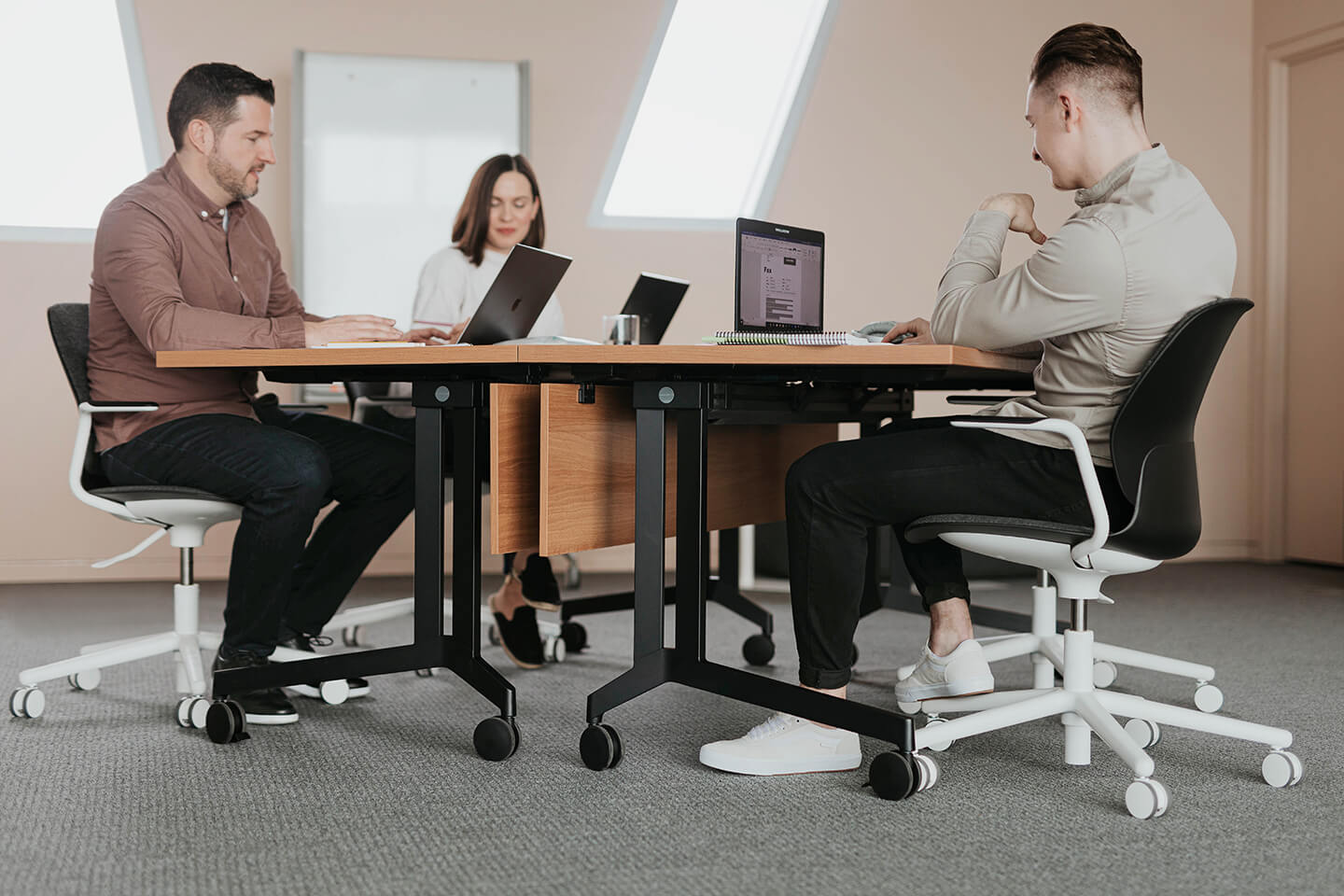 Haworth Planes Training Table with maple top in a closed meeting room for collaboration 