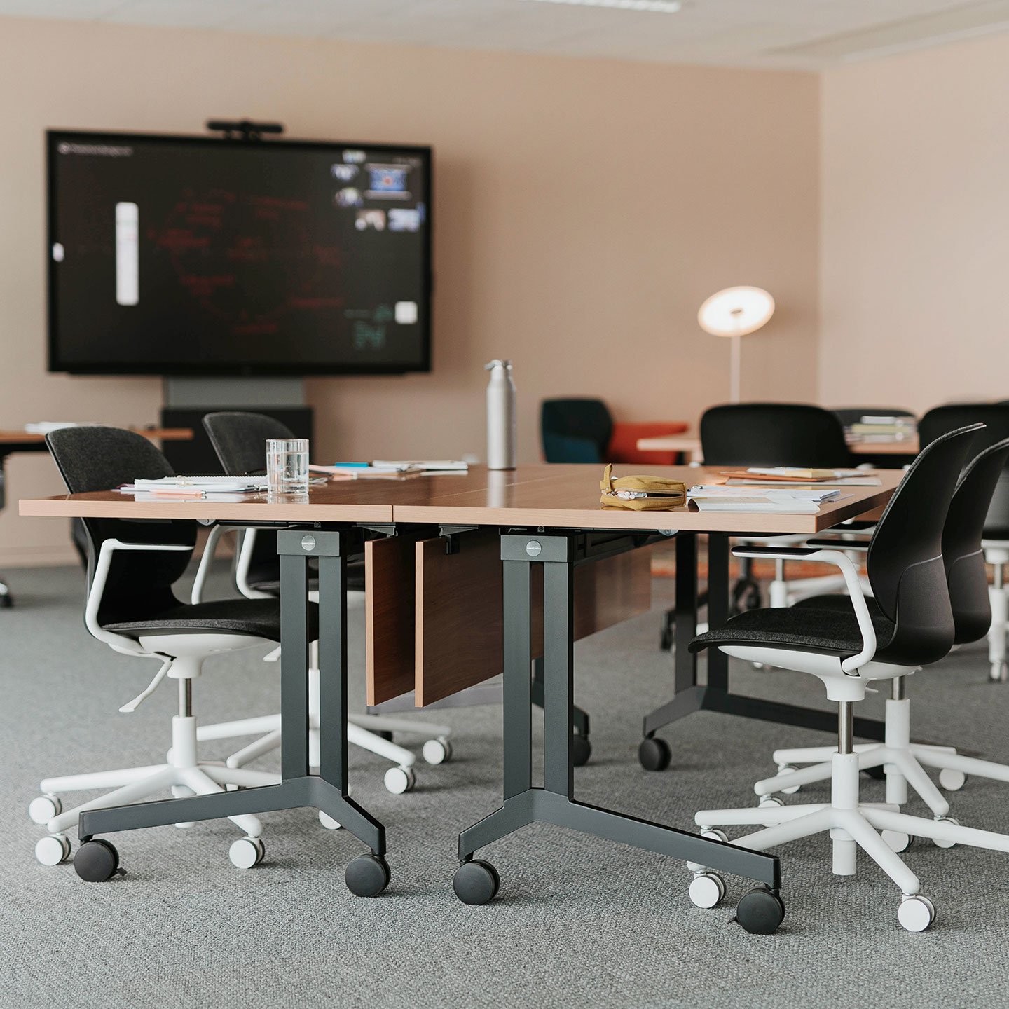 Haworth Planes Training Table in a closed meeting room with a monitor