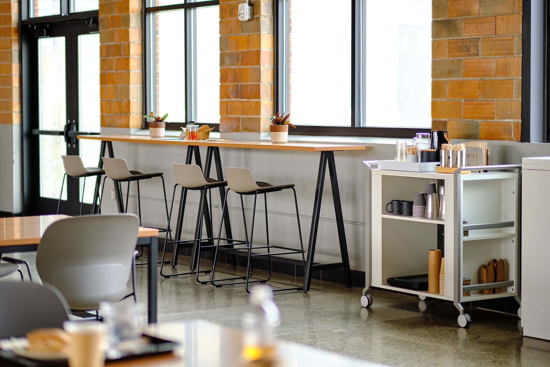 Haworth PopUp Table in office dining area set up next to windows with a dining cart next to it