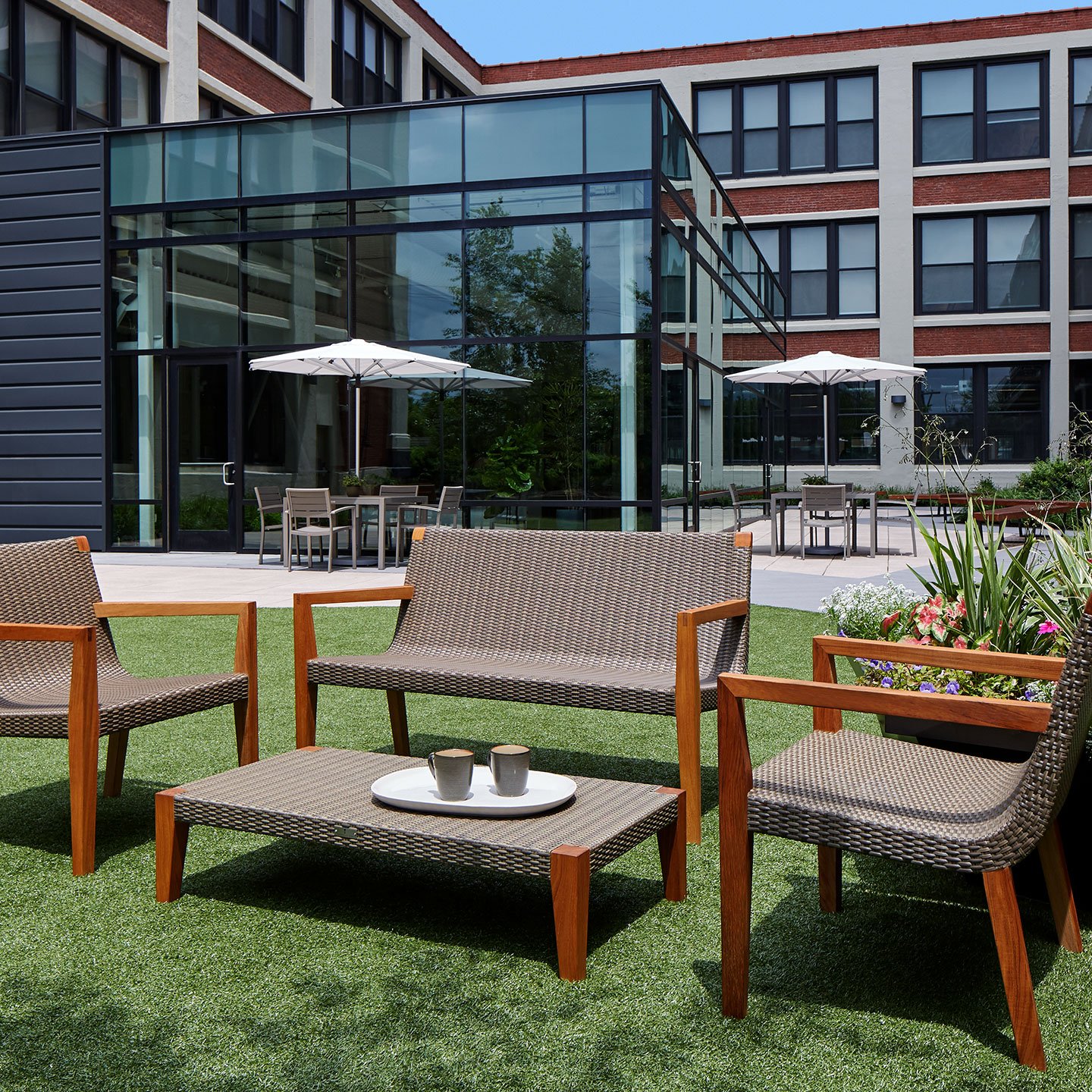 Haworth Quinta table with 4 legs and janusfiber top with quinta chairs in an outdoor patio outside of an office
