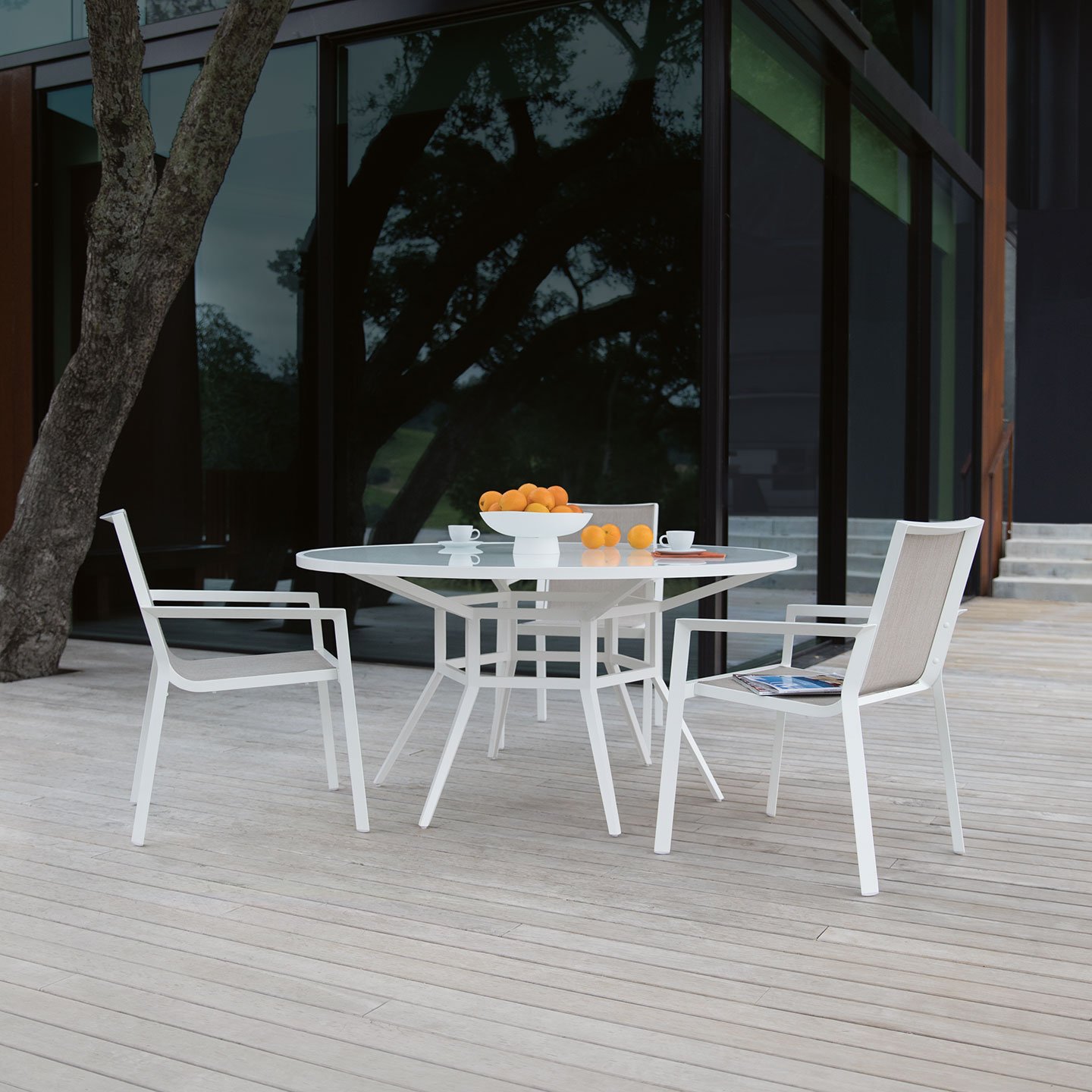 Haworth Slant Table with white top and white legs in outdoor patio area with fruit centerpiece